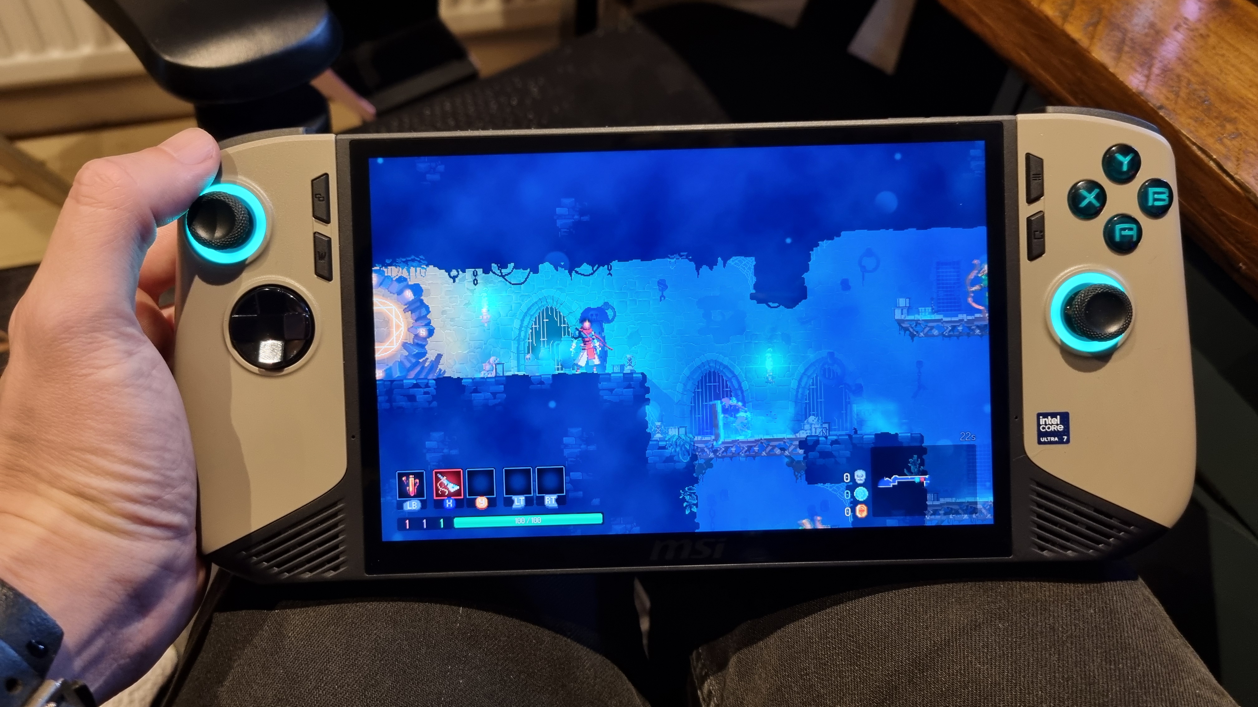 The MSI Claw 8 AI+ held in the hand, playing Dead Cells on the 8-inch screen.