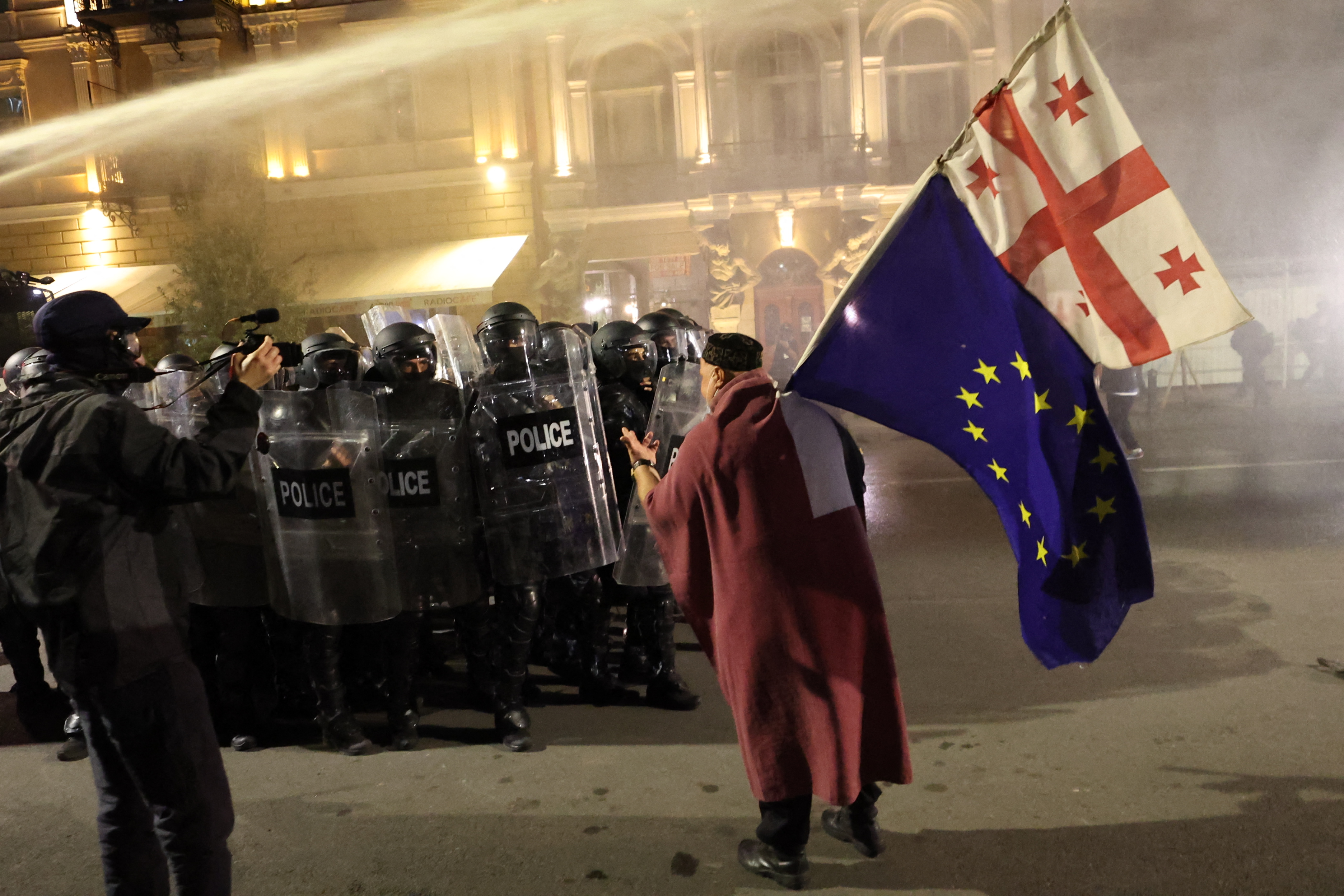 Riot police disperse protesters during an opposition rally on the day of local elections in central Tbilisi on October 4, 2025. (Photo by Giorgi ARJEVANIDZE / AFP)