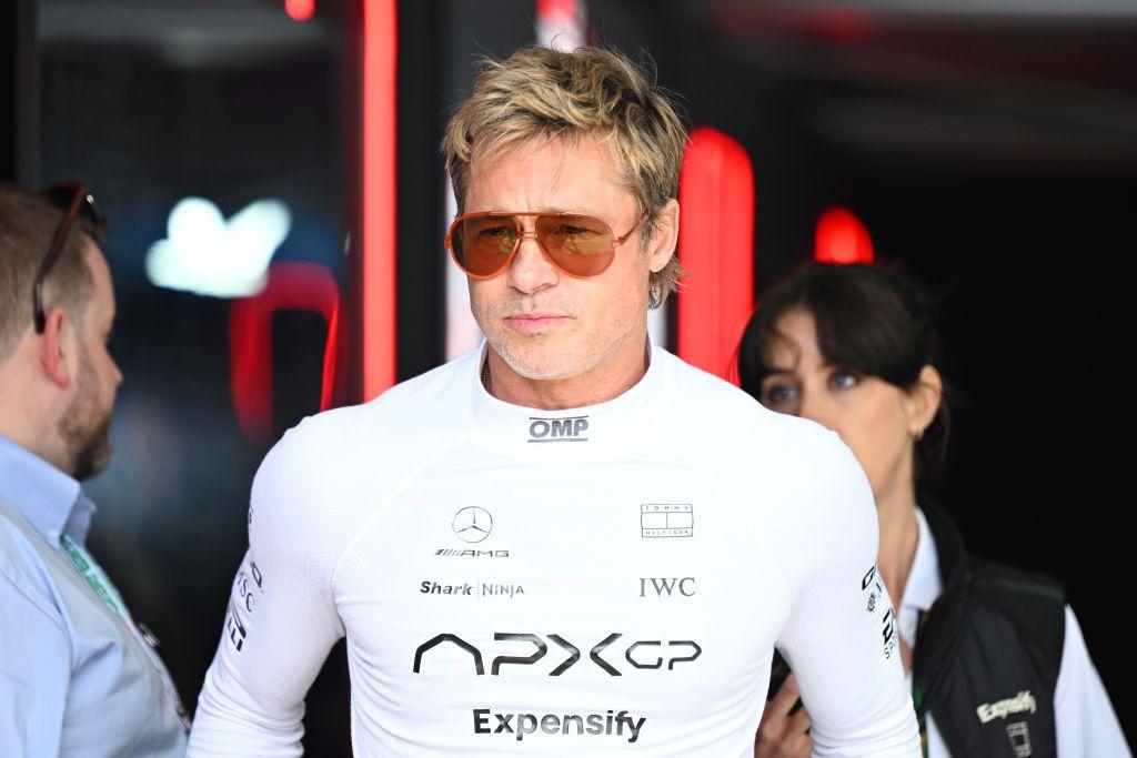 Picture of Brad Pitt in a white racing suit wearing sunglasses.