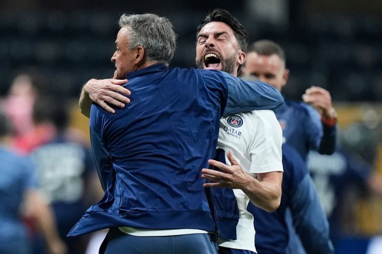 Paris Saint-Germain manager Luis Enrique celebrates with coaches after the Club World Cup quarterfinal soccer match between PSG and Bayern Munich in Atlanta, Saturday, July 5, 2025. (AP Photo/Mike Stewart)
