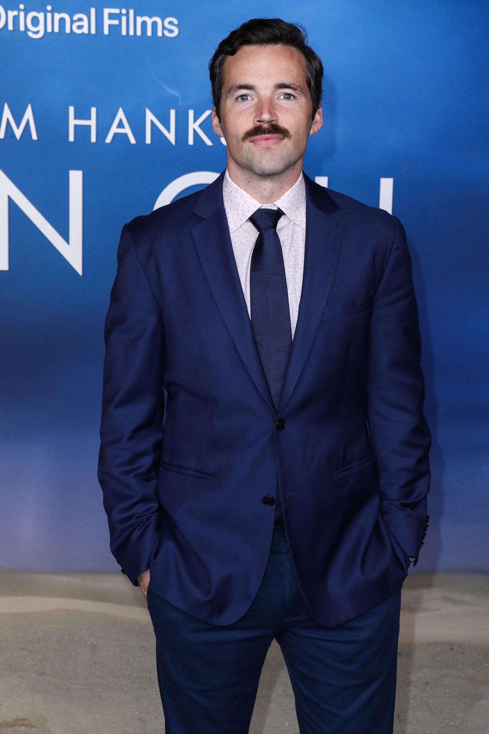 Ian Harding posing on the red carpet. 