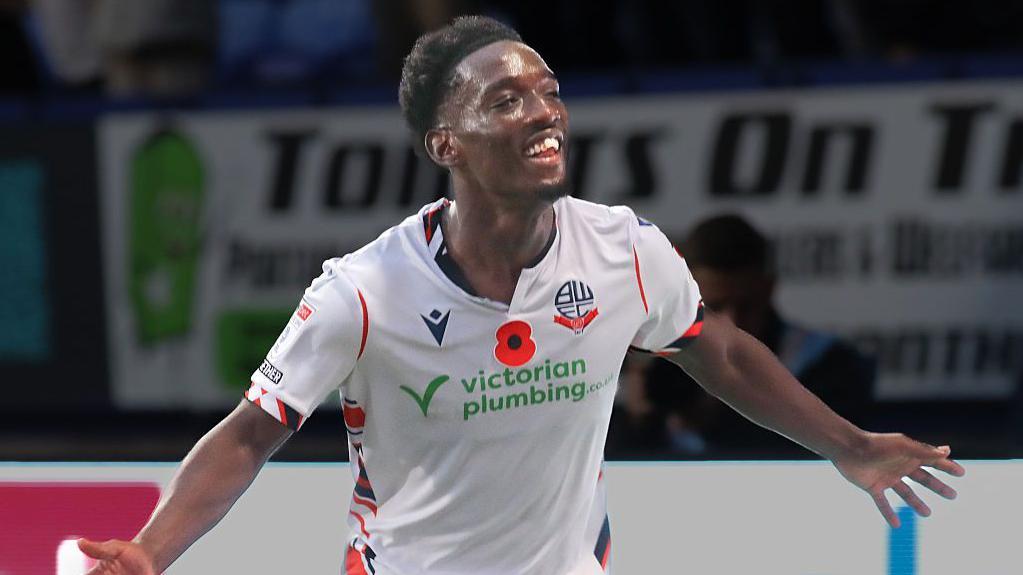 Amario Cozier-Dubbery spreads his arms to celebrate a goal against Port Vale