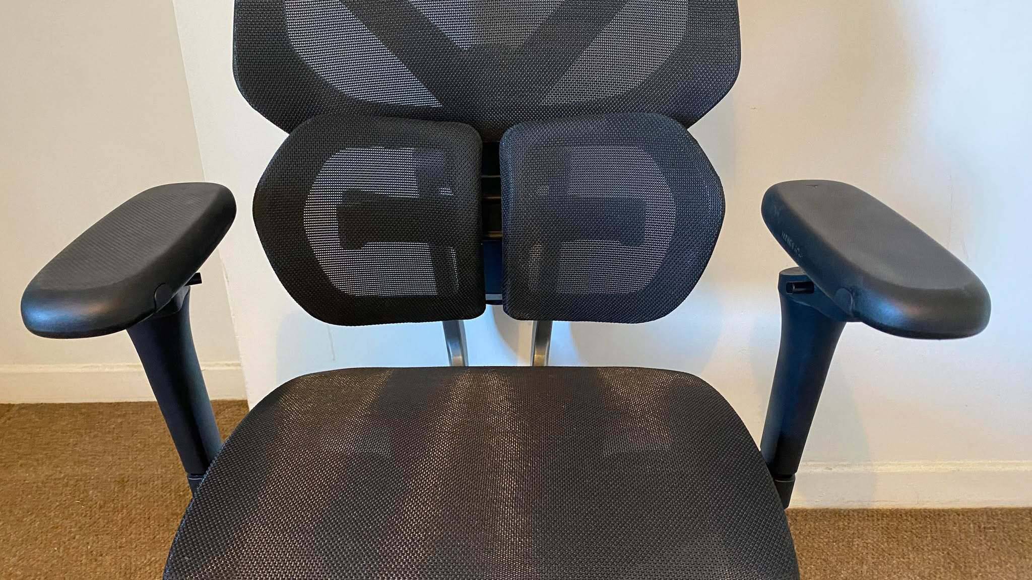 ThunderX3 chair set up in front of a white wall.