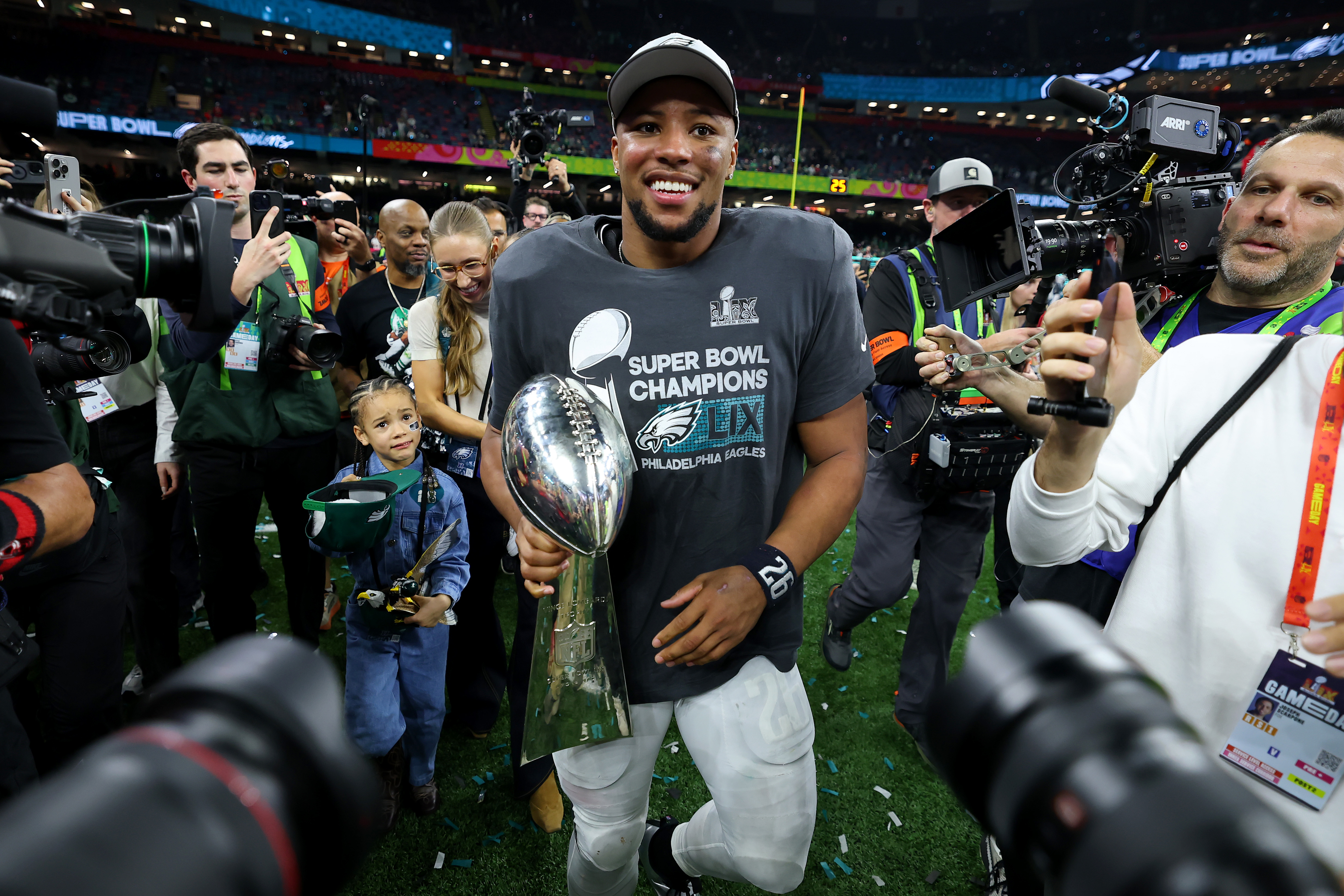 NEW ORLEANS, LOUISIANA - FEBRUARY 09: Saquon Barkley #26 of the Philadelphia Eagles celebrates with the Vince Lombardi Trophy after beating the Kansas City Chiefs 40-22 to win Super Bowl LIX at Caesars Superdome on February 09, 2025 in New Orleans, Louisiana. (Photo by Gregory Shamus/Getty Images)