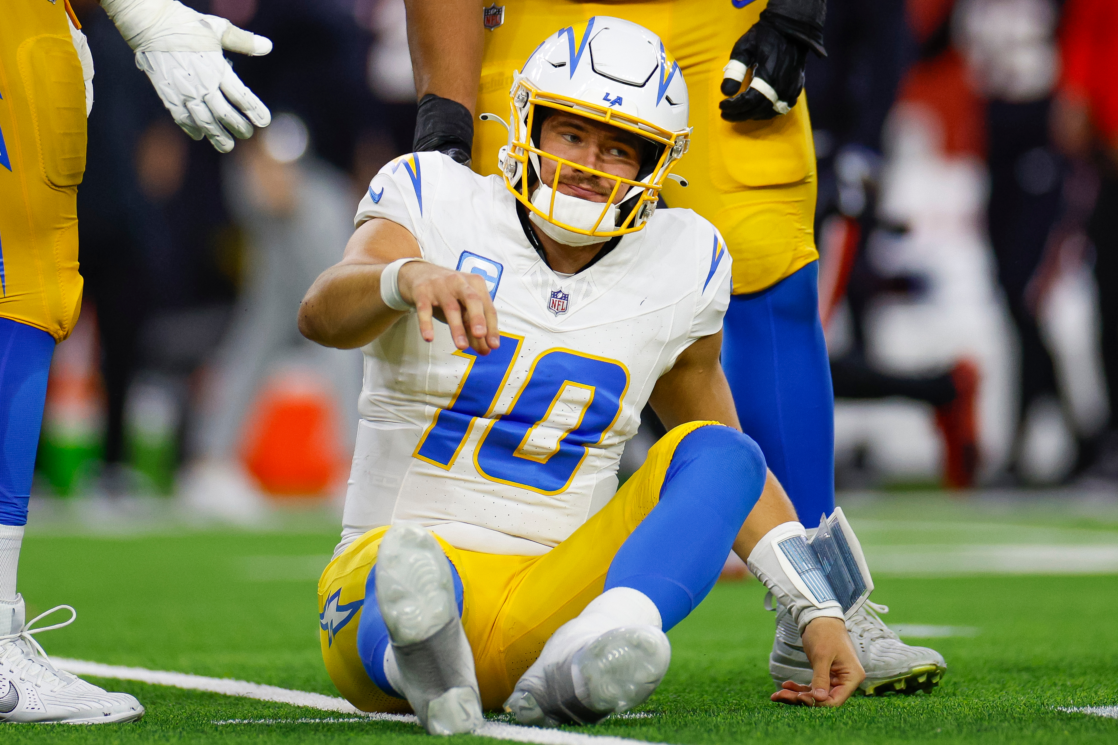 HOUSTON, TEXAS - JANUARY 11: Justin Herbert #10 of the Los Angeles Chargers reacts after being sacked during the second half of the AFC Wild Card Playoff game against the Houston Texans at NRG Stadium on January 11, 2025 in Houston, Texas. (Photo by Brandon Sloter/Getty Images)