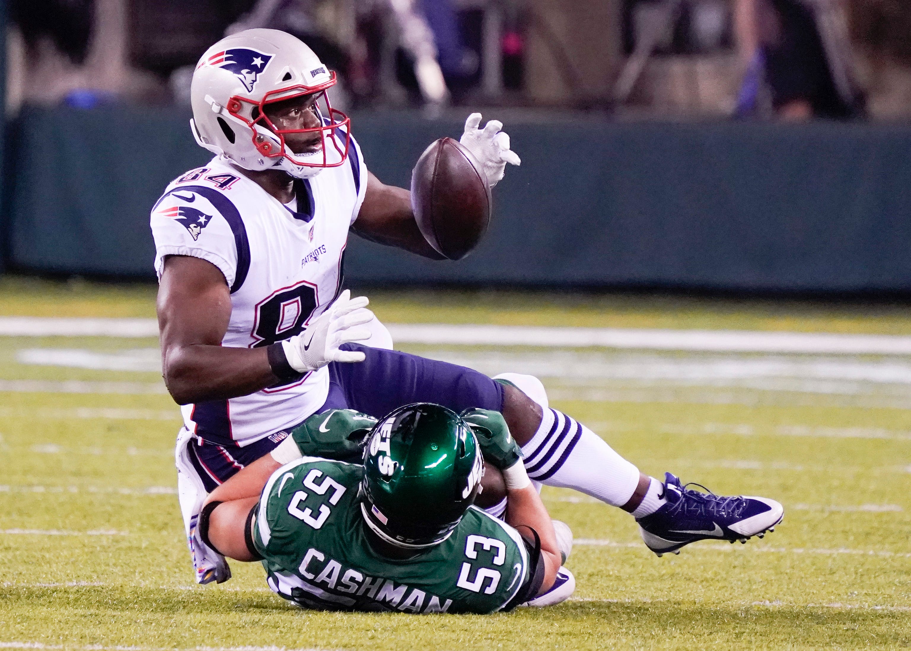 New England Patriots tight end Ben Watson manages to hold on to a pass for a first down.