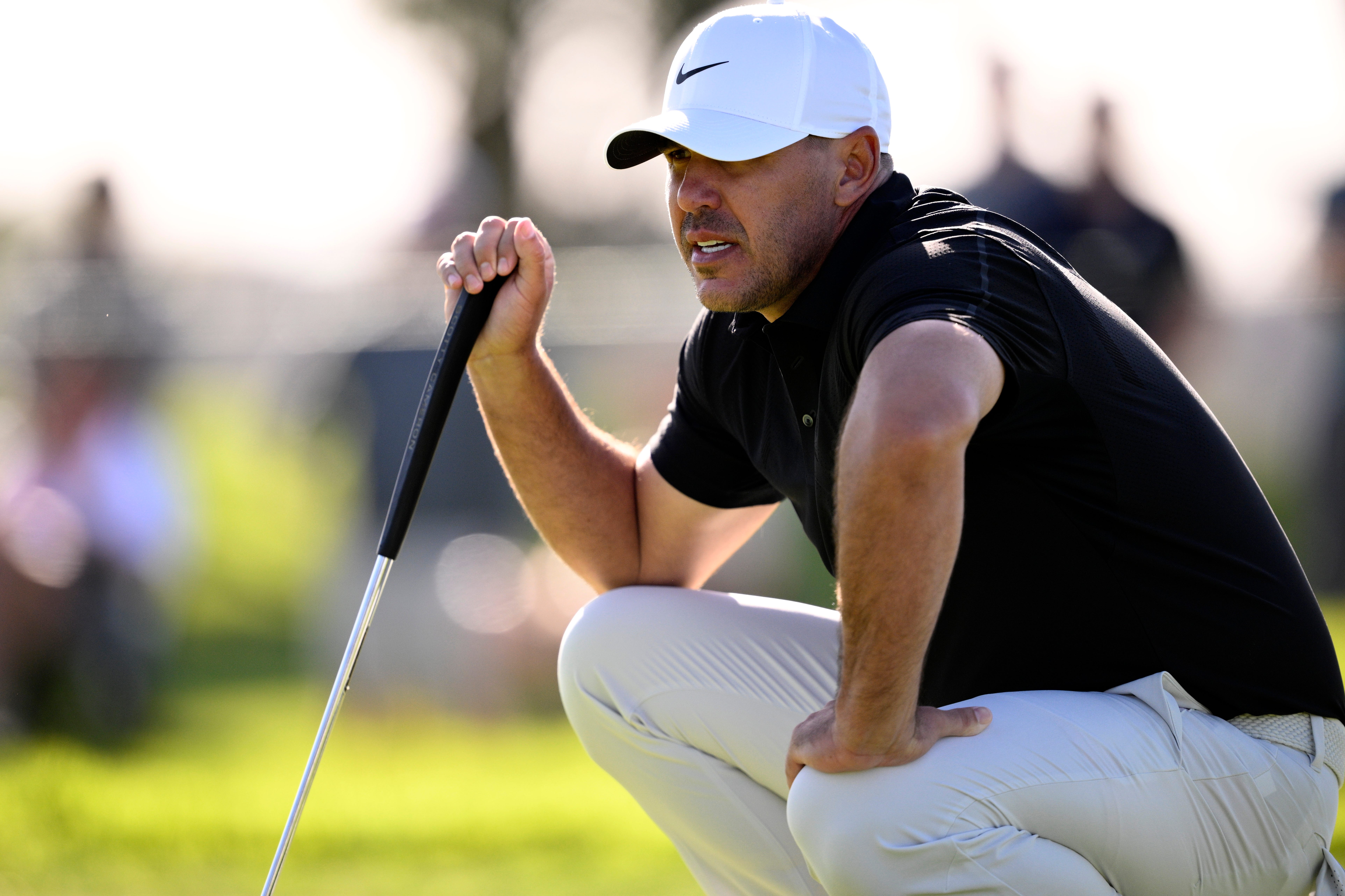 Brooks Koepka lines up a putt on the first hole during the first round of the 2026 Farmers Insurance Open at Torrey Pines South Course.