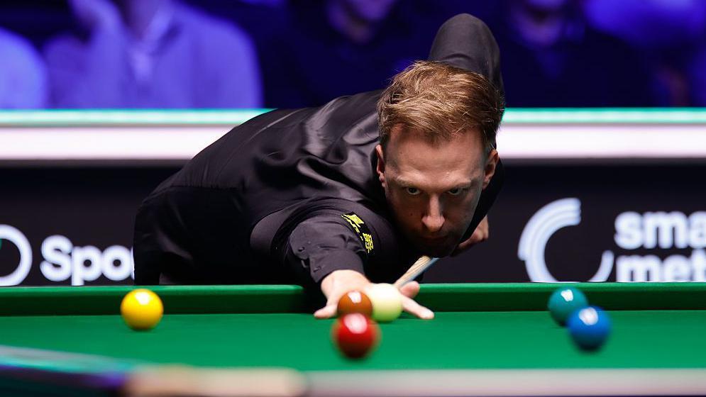 Judd Trump plays a shot