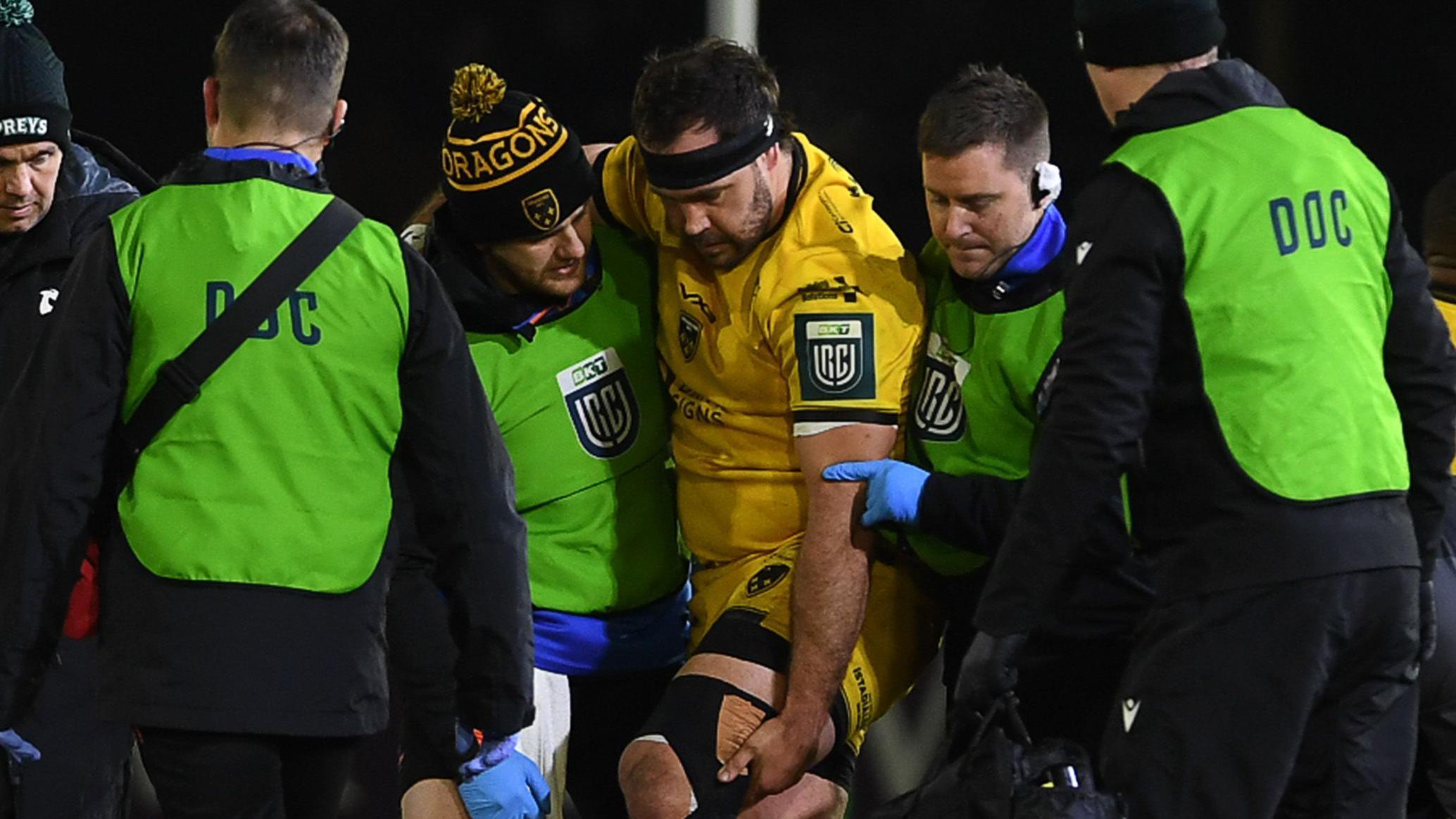 Dragons prop Rob Hunt is helped from the field after an injury against Ospreys