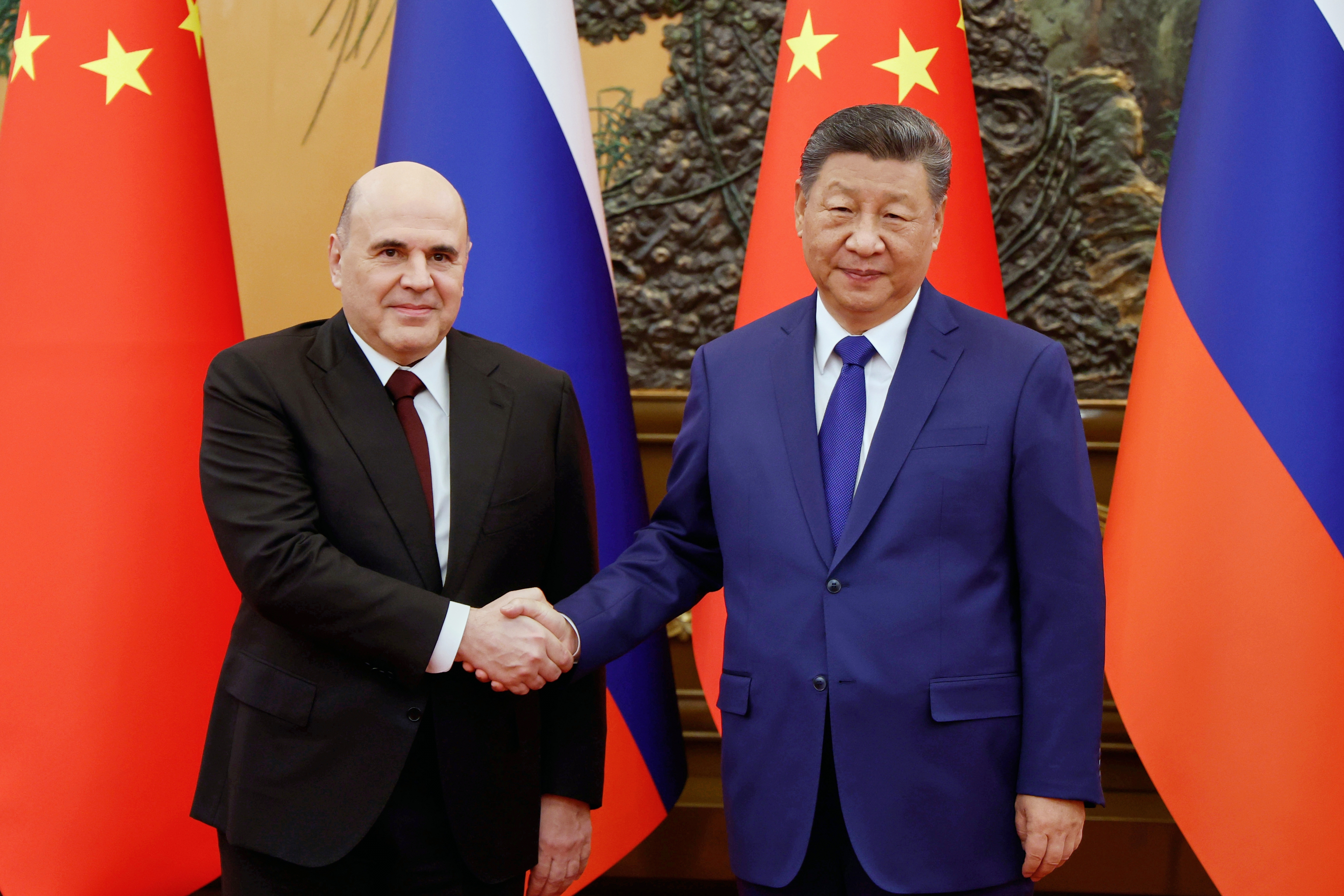 Chinese President Xi Jinping, right, and Russian Prime Minister Mikhail Mishustin pose for a photo prior to their talks at the People's Assembly House in Beijing, China, Tuesday, Nov. 4, 2025. (Dmitry Astakhov, Sputnik, Government Pool Photo via AP)