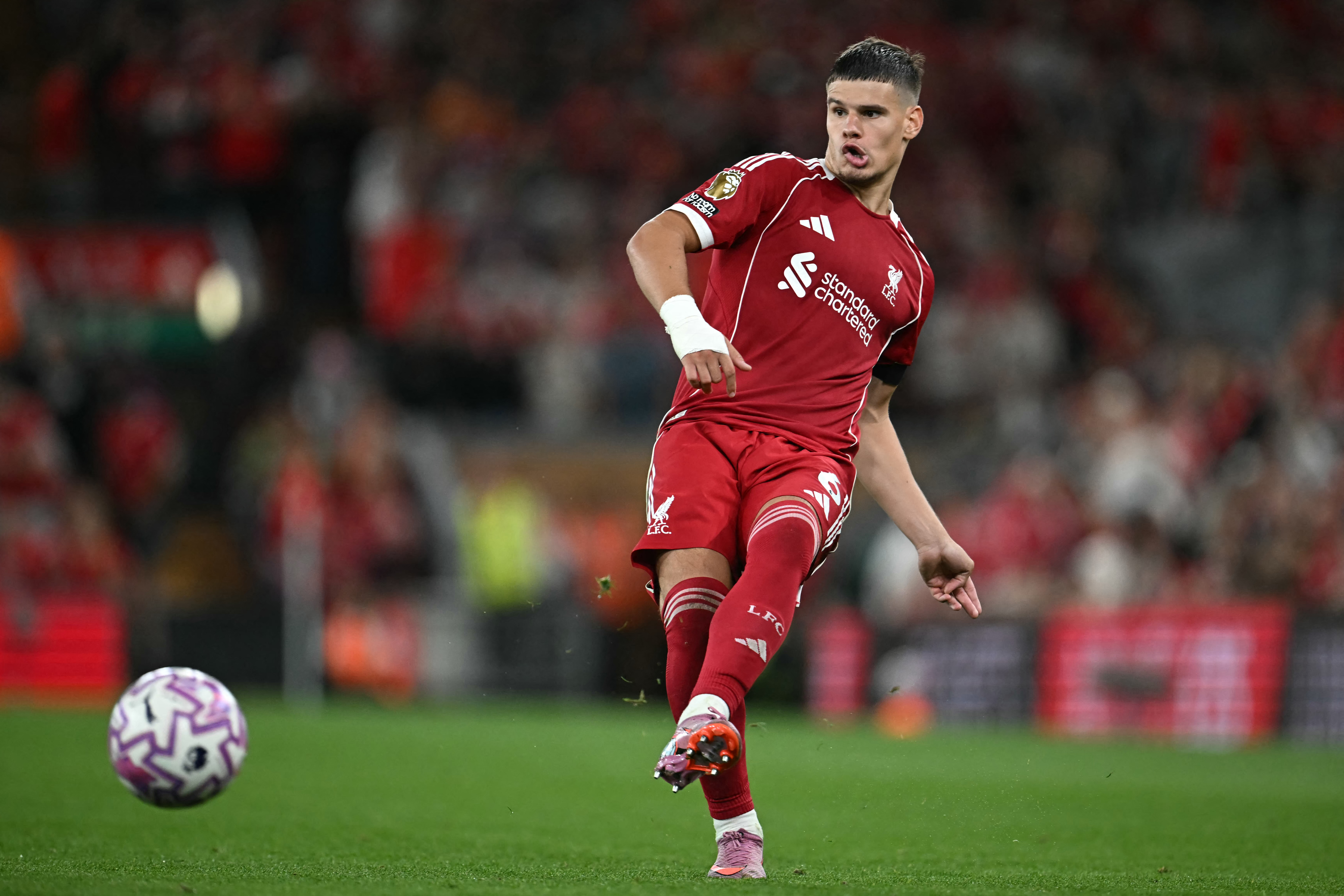 Liverpool's Hungarian defender #06 Milos Kerkez passes the ball during the English Premier League football match between Liverpool and Bournemouth at Anfield in Liverpool, north west England on August 15, 2025. (Photo by Paul ELLIS / AFP) / RESTRICTED TO EDITORIAL USE. No use with unauthorized audio, video, data, fixture lists, club/league logos or 'live' services. Online in-match use limited to 120 images. An additional 40 images may be used in extra time. No video emulation. Social media in-match use limited to 120 images. An additional 40 images may be used in extra time. No use in betting publications, games or single club/league/player publications. / (Photo by PAUL ELLIS/AFP via Getty Images)