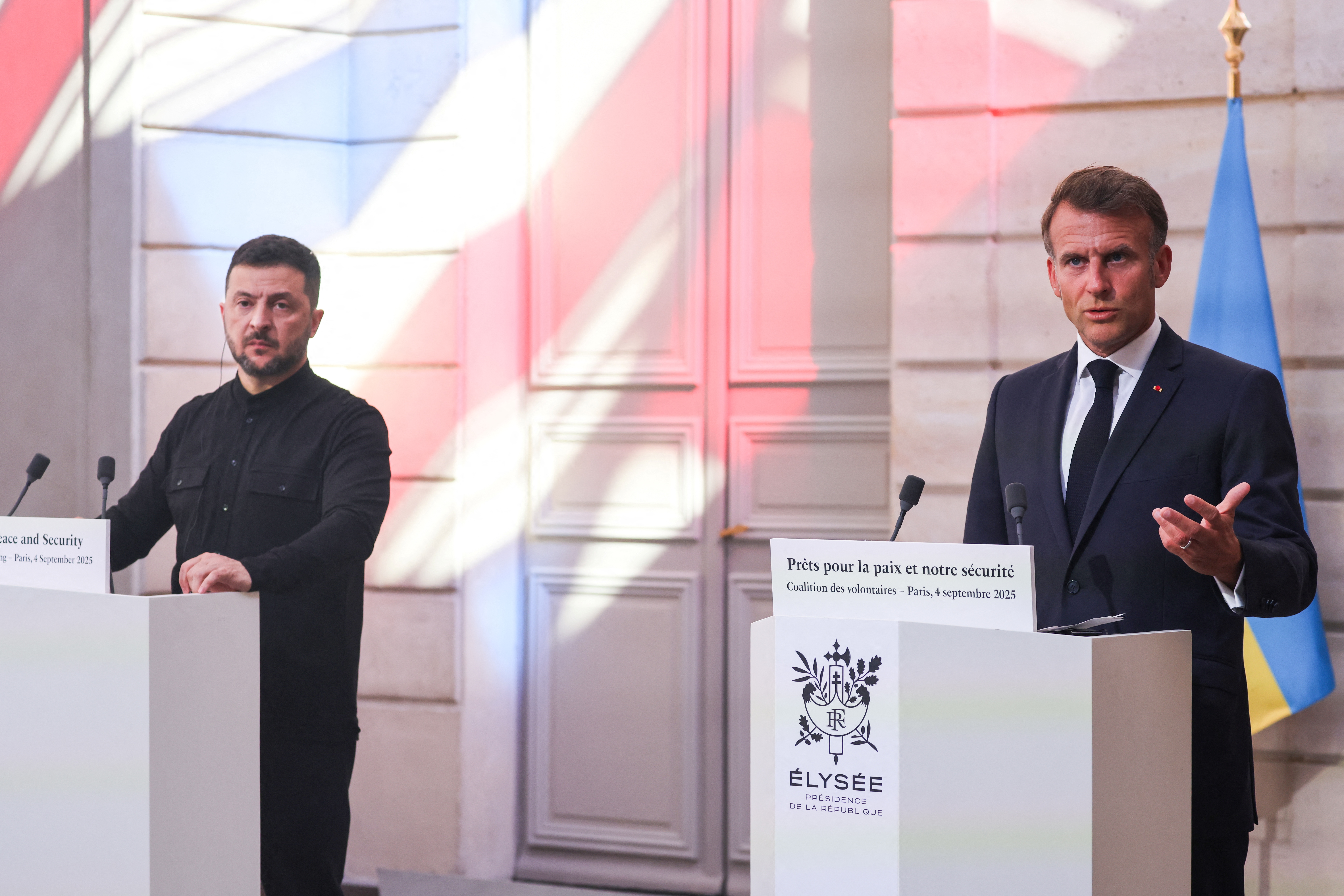 Ukraine's President Volodymyr Zelensky (L) and France's President Emmanuel Macron (R) speak during a press conference following the Coalition of the Willing Summit, at the Elysee presidential Palace, in Paris, on September 4, 2025.