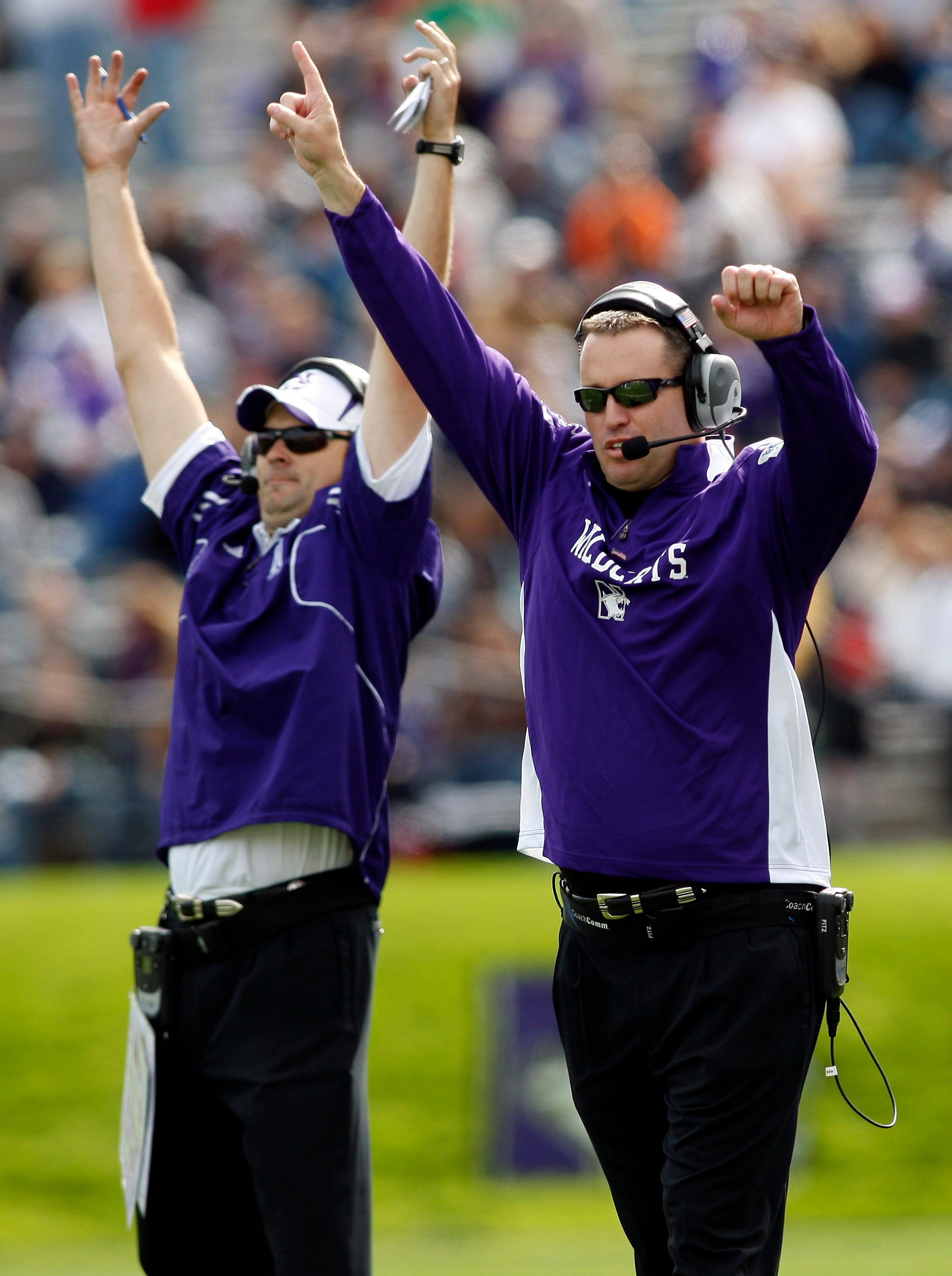 Sep 25, 2010; Evanston, IL, USA; Northwestern Wildcats head coach Pat Fitzgerald (right) and offensive line coach Adam Cushing (left) celebrate after a touchdown during the fourth quarter against the Central Michigan Chippewas at Ryan Field. Northwestern won 30-25. Mandatory Credit: Jerry Lai-USA TODAY Sports
