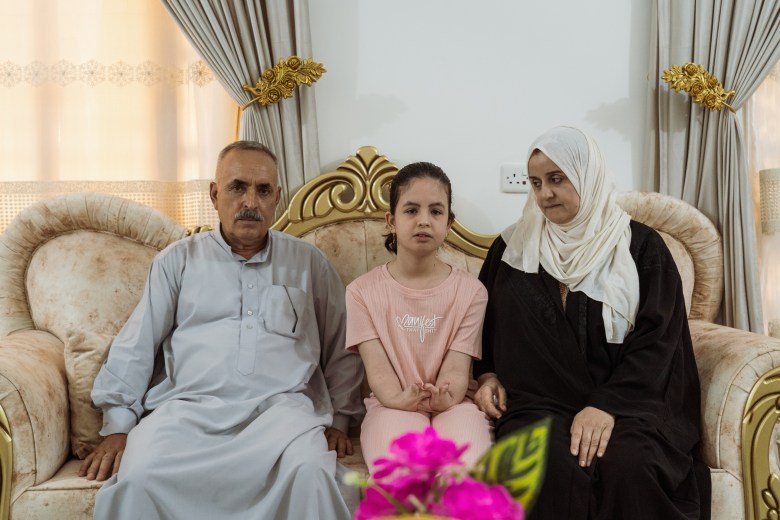 Fatema sits beside her mother and father in Fallujah. Photo by Jaclynn Ashly.