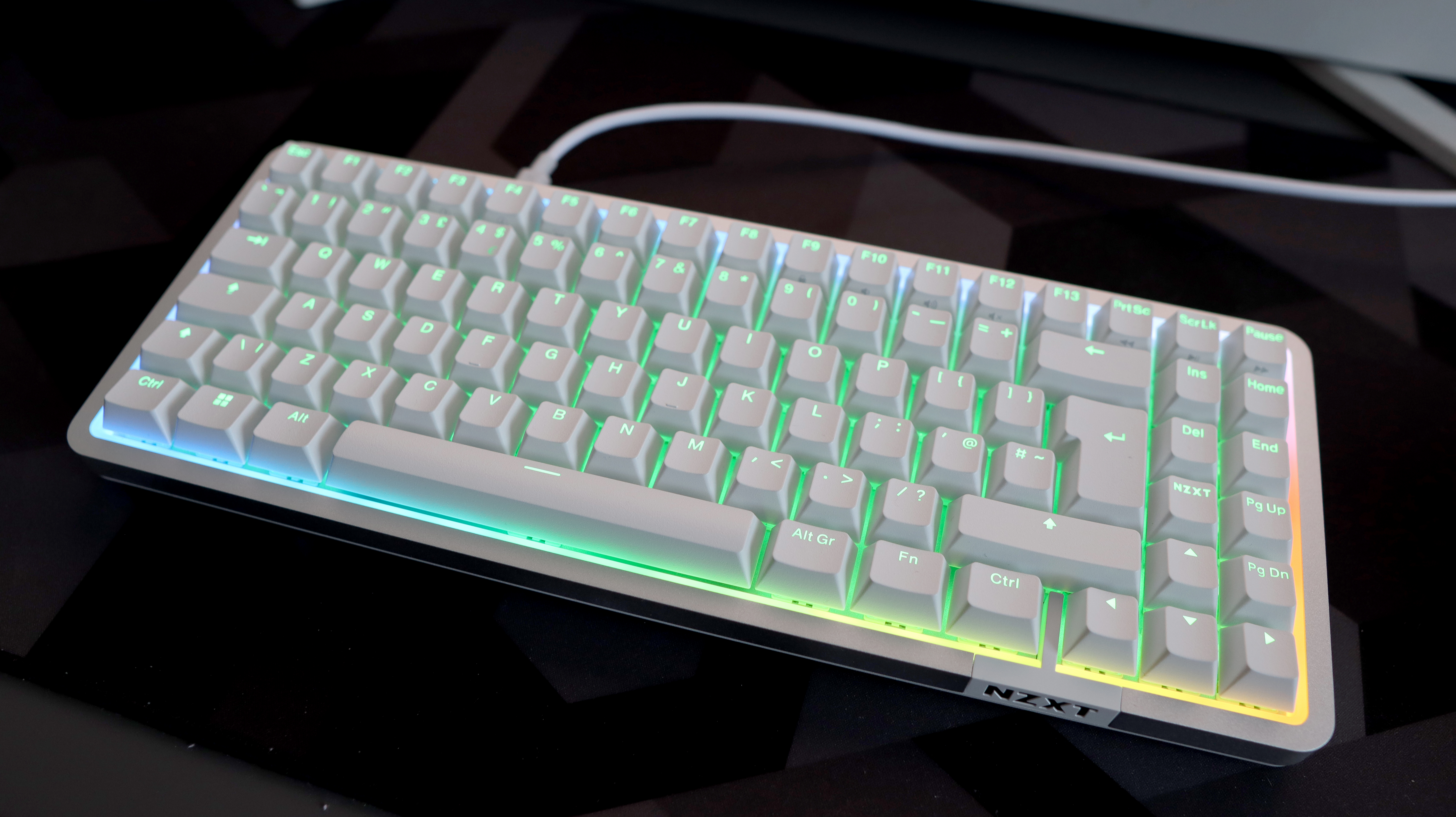 NZXT Function Elite MiniTKL with RGB lighting enabled on a desk.