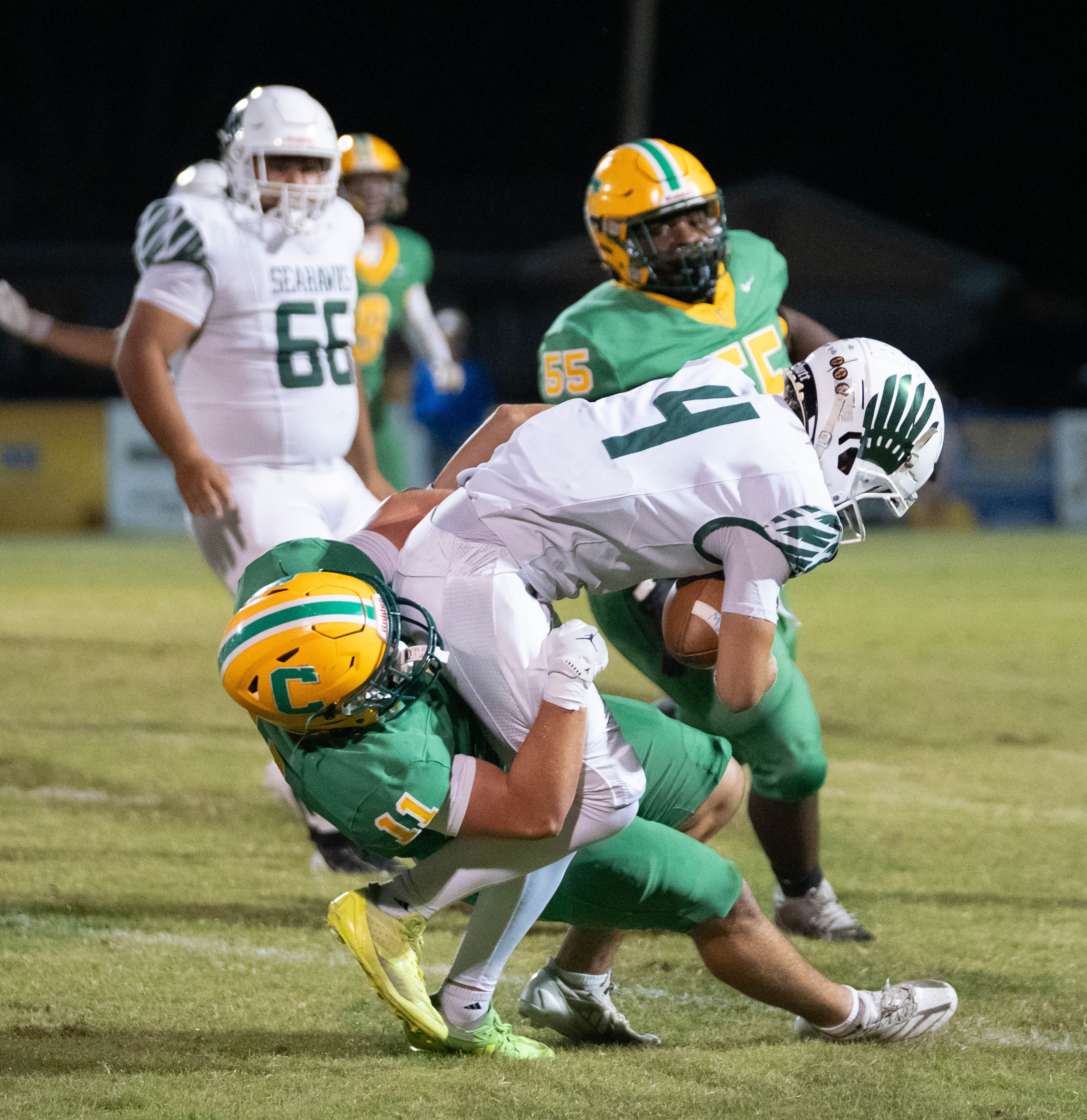 Pensacola Catholic's Kaleb Johnson (11) tackles South Walton's Gabe Parenton (4) during their football game at Pensacola Catholic High School on Oct. 24, 2025.