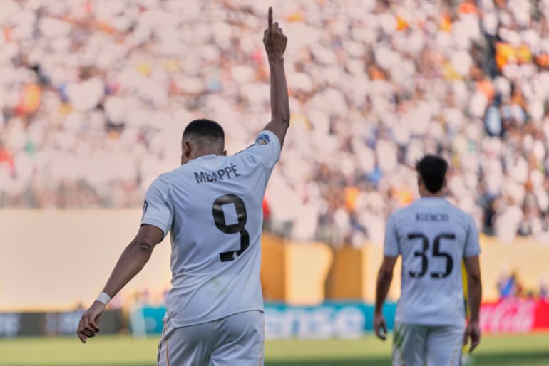 Real Madrid's Kylian Mbappe, left, reacts after scoring a goal against Borussia Dortmund in extra time of a Club World Cup quarterfinal soccer match, Saturday, July 5, 2025 in East Rutherford, N.J. (AP Photo/Frank Franklin II)