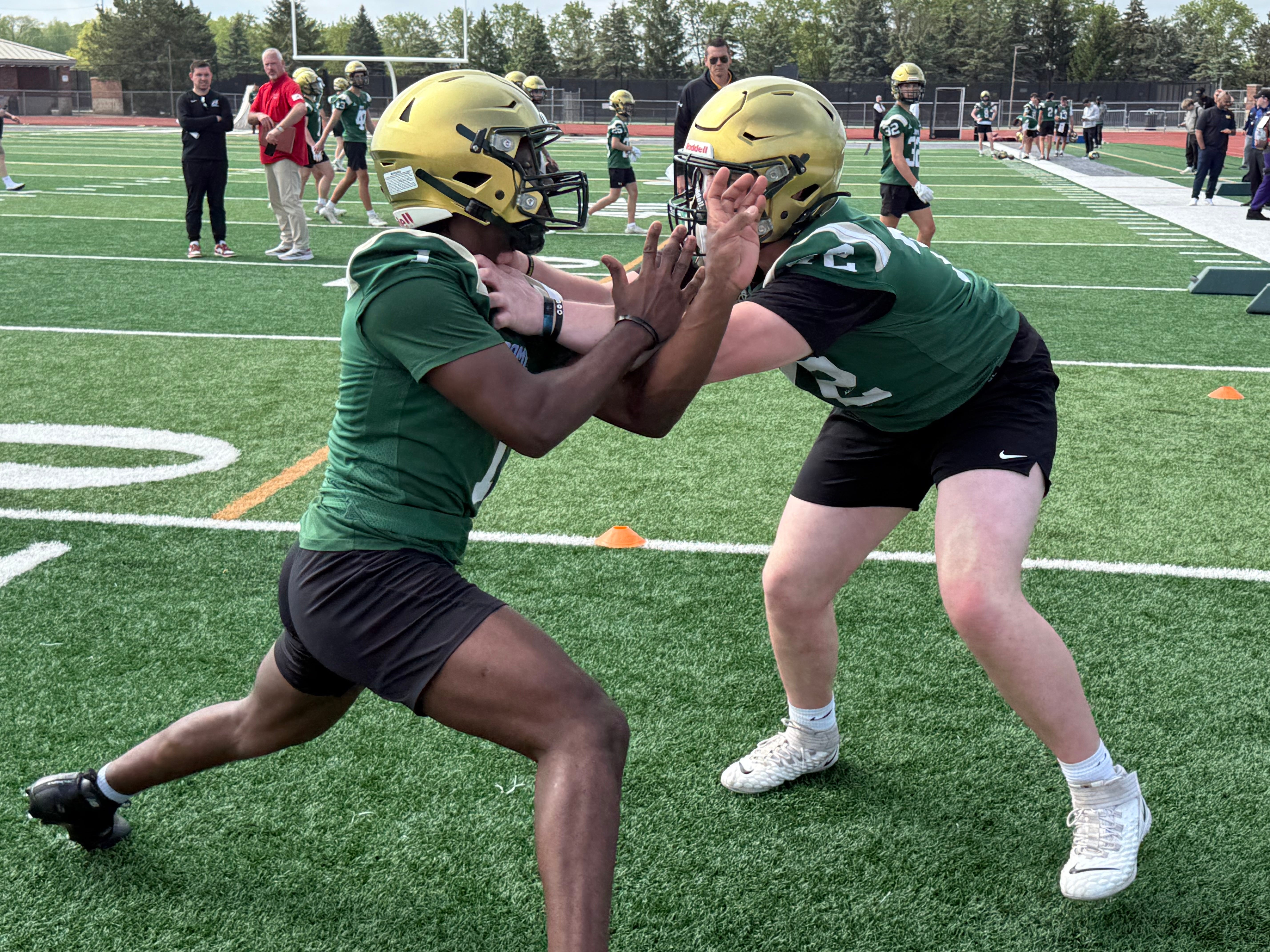 Dublin Jerome's Kwame Bosley, left, and Nick Jackson participate in a blocking drill during a 2025 college football showcase day at Dublin Scioto.