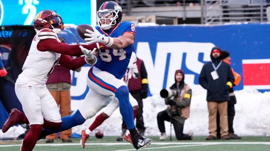 New York Giants tight end Theo Johnson (84) catches a ball by Washington Commanders cornerback Noah Igbinoghene (6), Sunday, December 14, 2025.