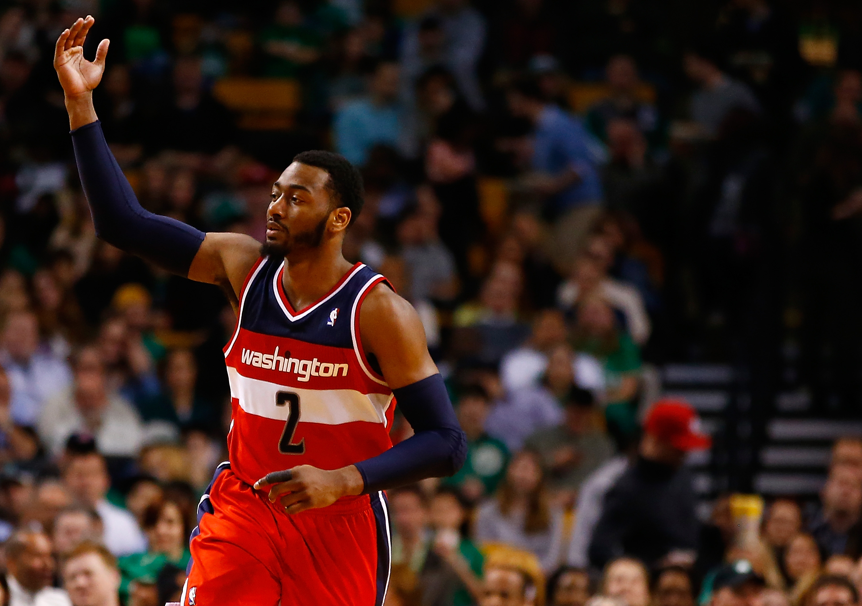 BOSTON, MA - APRIL 16: John Wall #2 of the Washington Wizards reacts following a three-point shot against the Boston Celtics in the second quarter during the game at TD Garden on April 16, 2014 in Boston, Massachusetts. NOTE TO USER: User expressly acknowledges and agrees that, by downloading and or using this photograph, User is consenting to the terms and conditions of the Getty Images License Agreement. (Photo by Jared Wickerham/Getty Images)