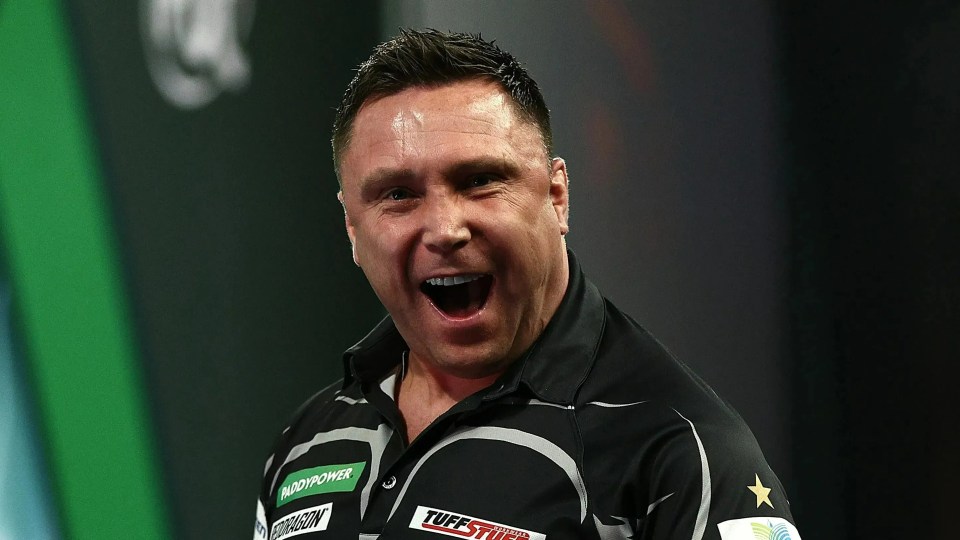 Gerwyn Price celebrating during a darts match.