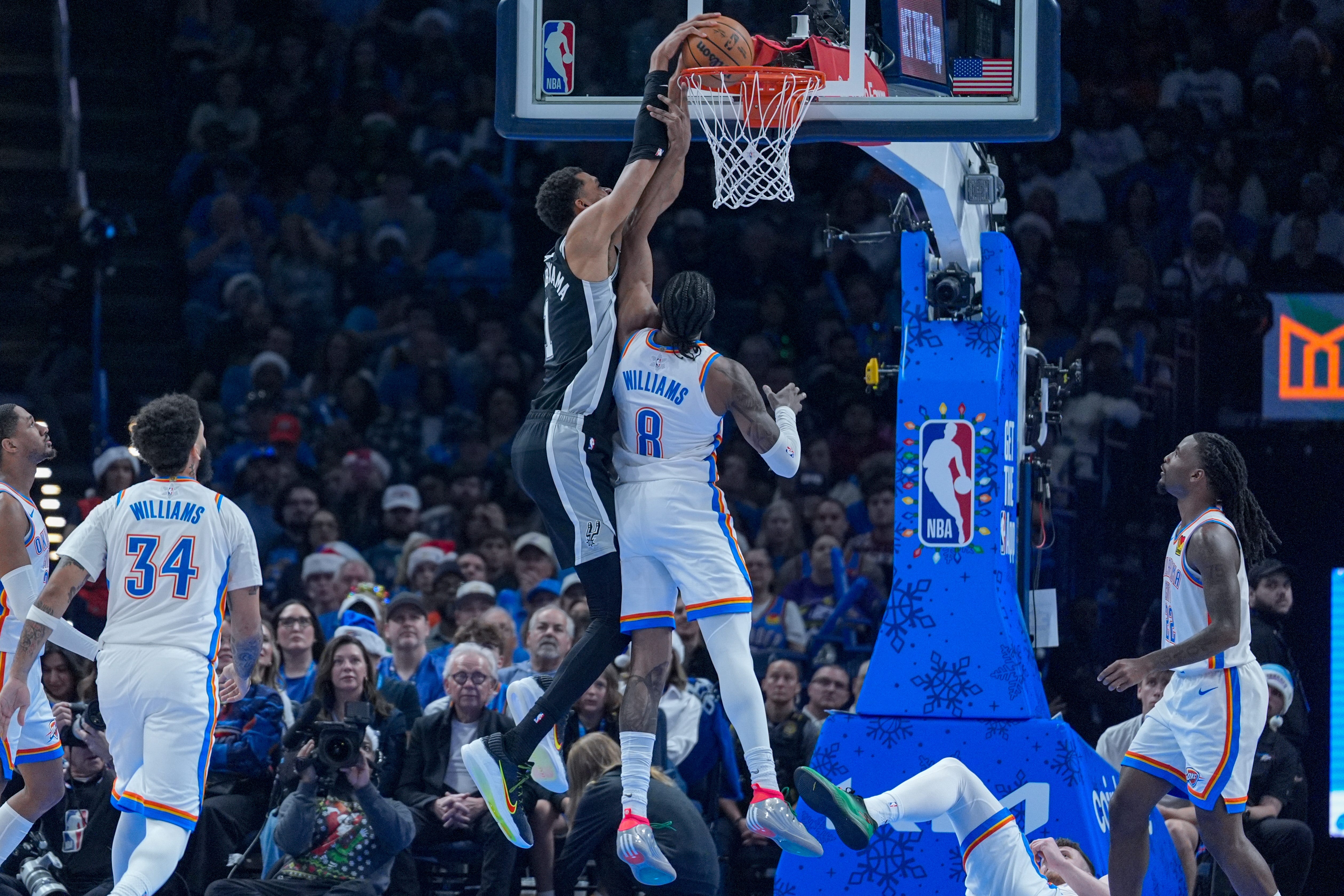San Antonio forward Victor Wembanyama (1) dunks over Oklahoma City guard Jalen Williams (8) in the second quarter during an NBA game between The Oklahoma City Thunder and The San Antonio Spurs at Paycom Center in Oklahoma City on Thursday, Dec. 25, 2025.