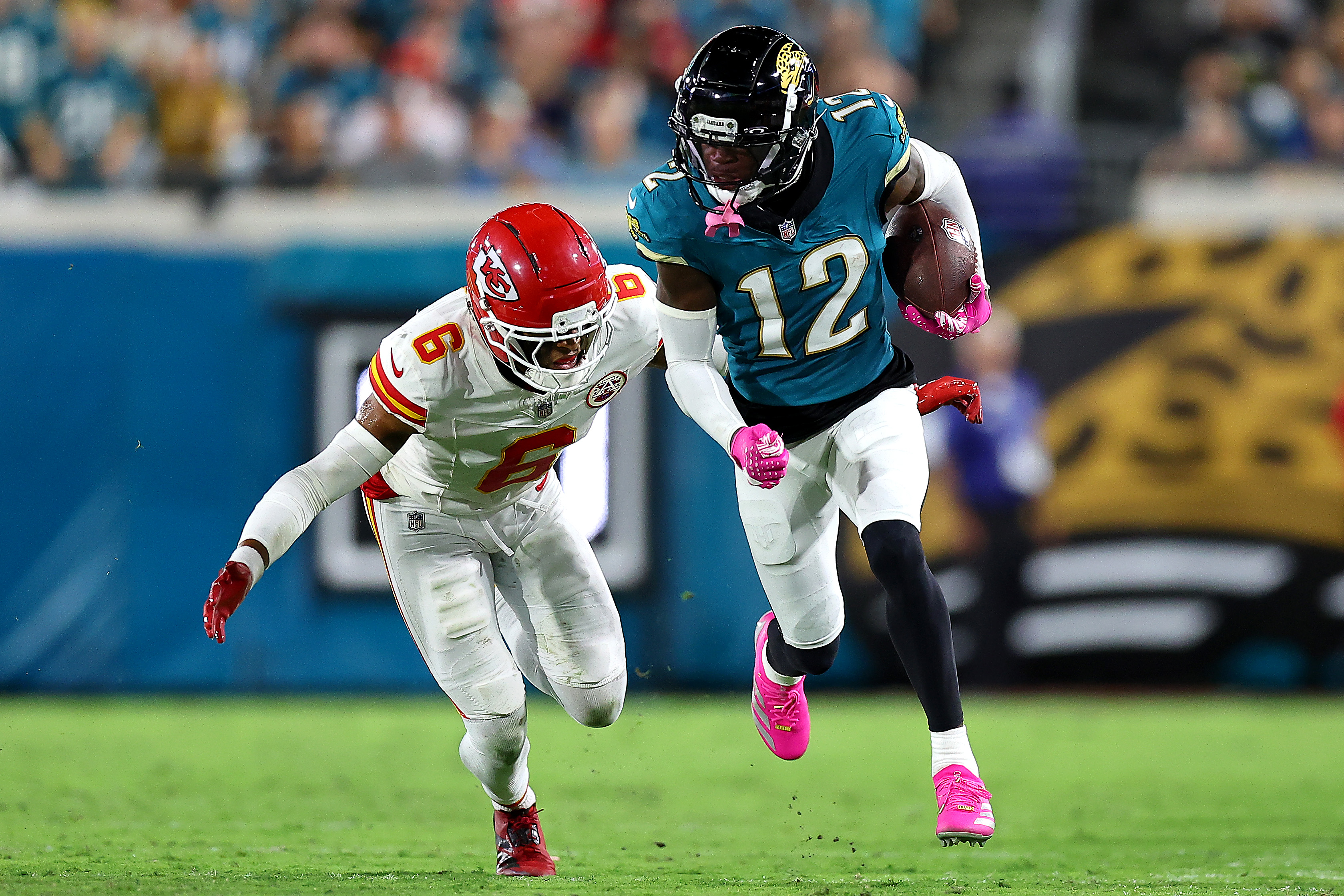 JACKSONVILLE, FLORIDA - OCTOBER 06: Travis Hunter #12 of the Jacksonville Jaguars runs the ball after a catch against Bryan Cook #6 of the Kansas City Chiefs during the second quarter at EverBank Stadium on October 06, 2025 in Jacksonville, Florida. (Photo by Mike Carlson/Getty Images)