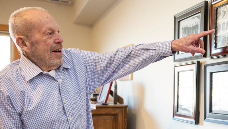 Marvin Melville points to pictures of old United States Olympic teams hanging on the wall at his home in Cottonwood Heights on Monday, Dec. 15, 2025.