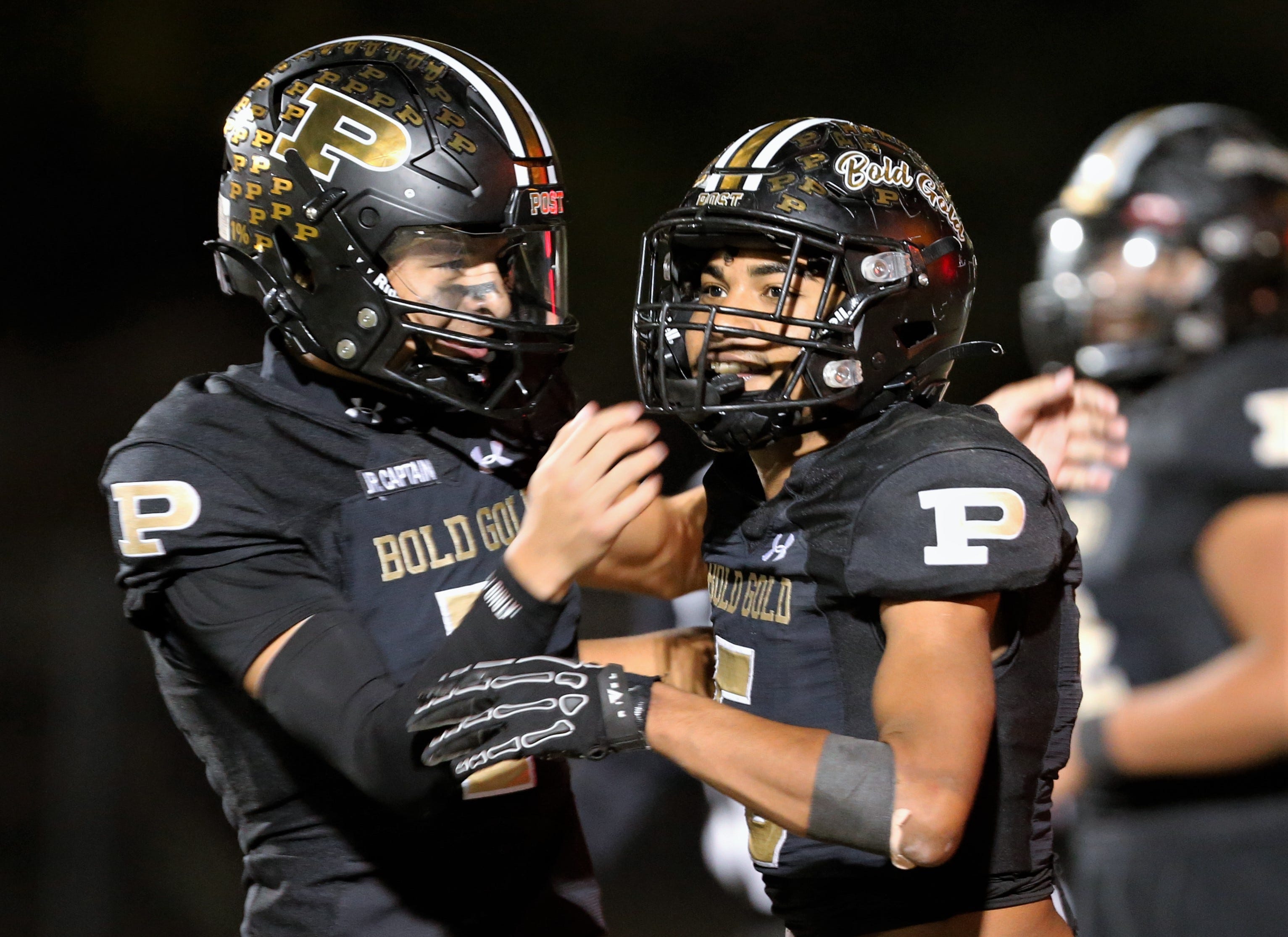 Post's Landyn Garcia, left and Randon Curtis celebrate Curtis' touchdown against Abernathy in a District 2-2A Division I football game Friday, Nov. 7, 2025, at Jimmie Redman Memorial Stadium in Post.