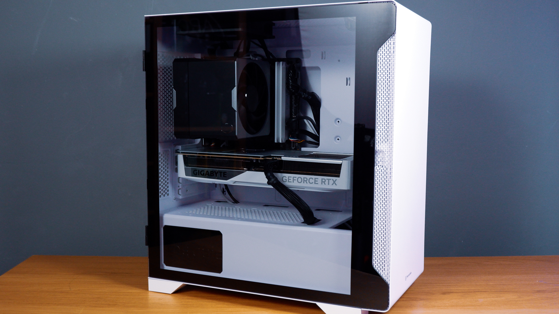A white gaming PC built using a Thermaltake PC case, Cooler Master fans, and an AMD CPU.