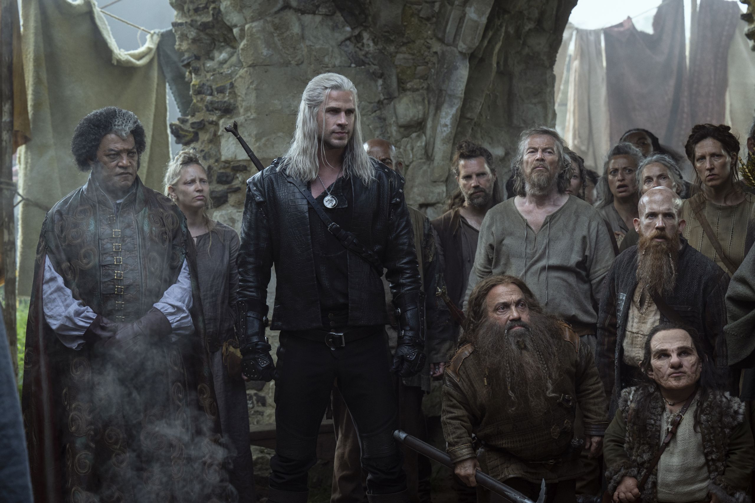 Regis, Geralt, Zoltan, Yarpin, and Percival in a crowd of local color