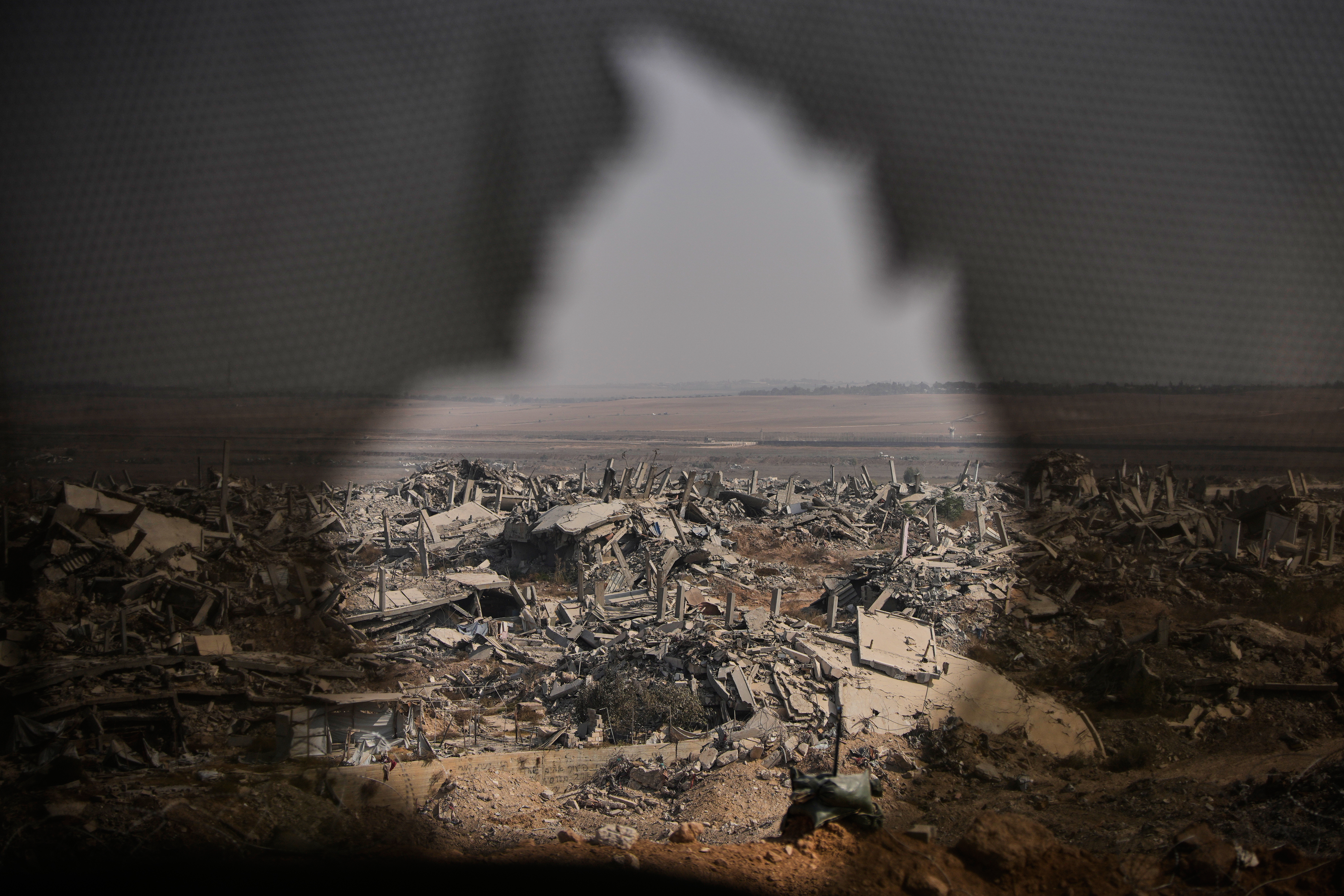 Buildings destroyed by the Israeli military lie in ruins, seen from an army post in the Shijaiya neighborhood of Gaza City, during an army-organized tour for journalists, Wednesday, Nov. 5, 2025. (AP Photo/Ohad Zwigenberg)
