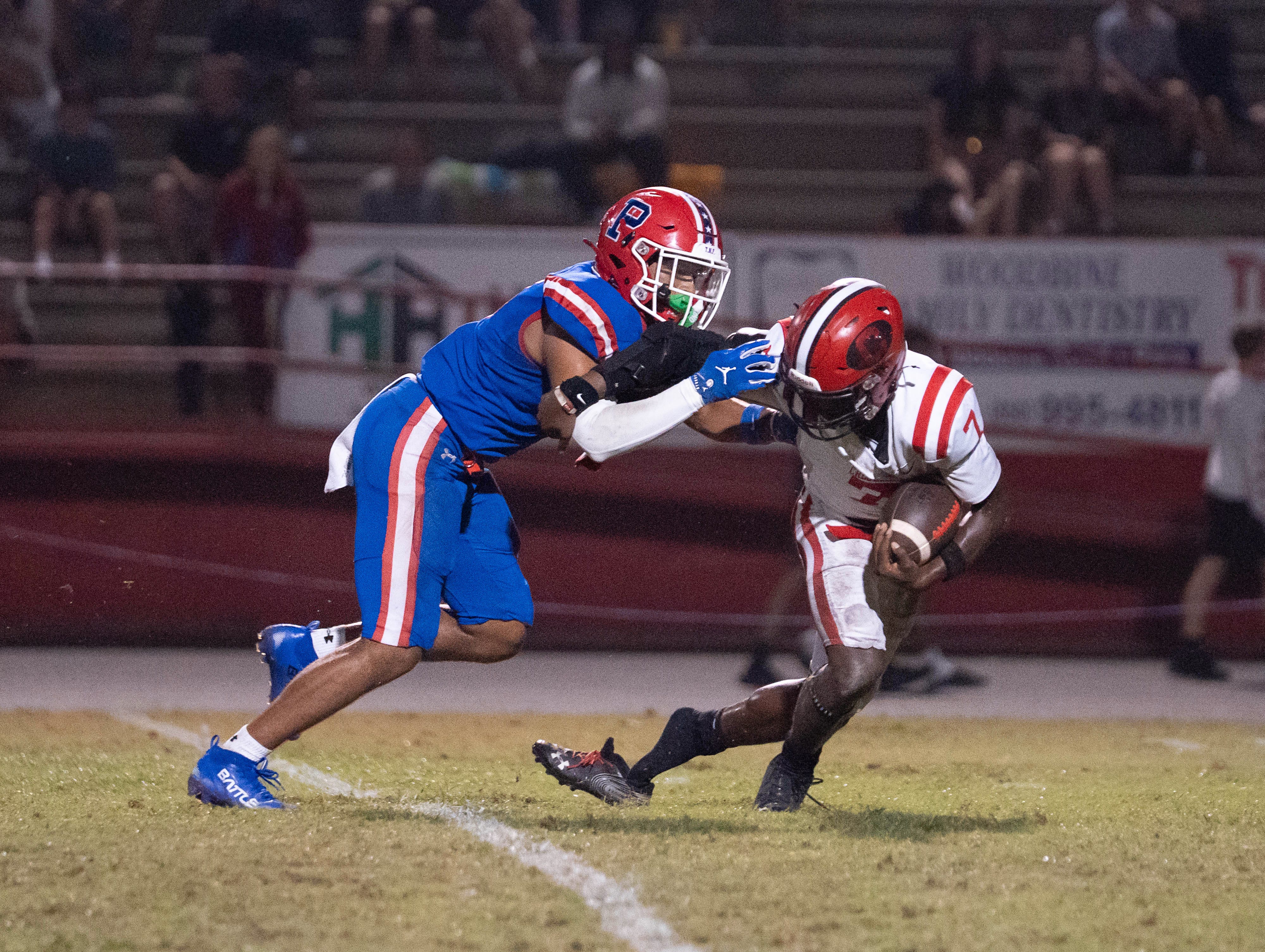 Bulldogs Manwell Robinson (7) loses a shoe as he is tackled by Patriots Noah Hamlin (18) during the Crestview vs Pace football game at Pace High School on Sept. 26, 2025.