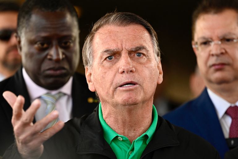 Former Brazilian President Jair Bolsonaro speaks to the press at the Federal Senate in Brasilia on July 17, 2025.