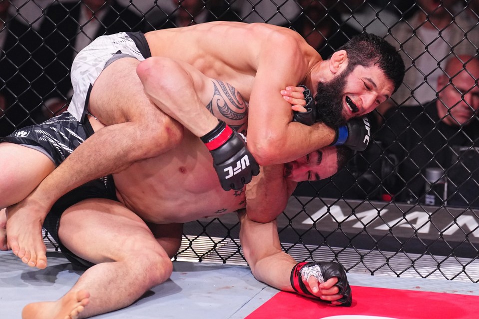ABU DHABI, UNITED ARAB EMIRATES - OCTOBER 26: (L-R) Khamzat Chimaev of Russia secures a submission against Robert Whittaker of New Zealand in a middleweight fight during the UFC 308 event at Etihad Arena on October 26, 2024 in Abu Dhabi, United Arab Emirates. (Photo by Chris Unger/Zuffa LLC)