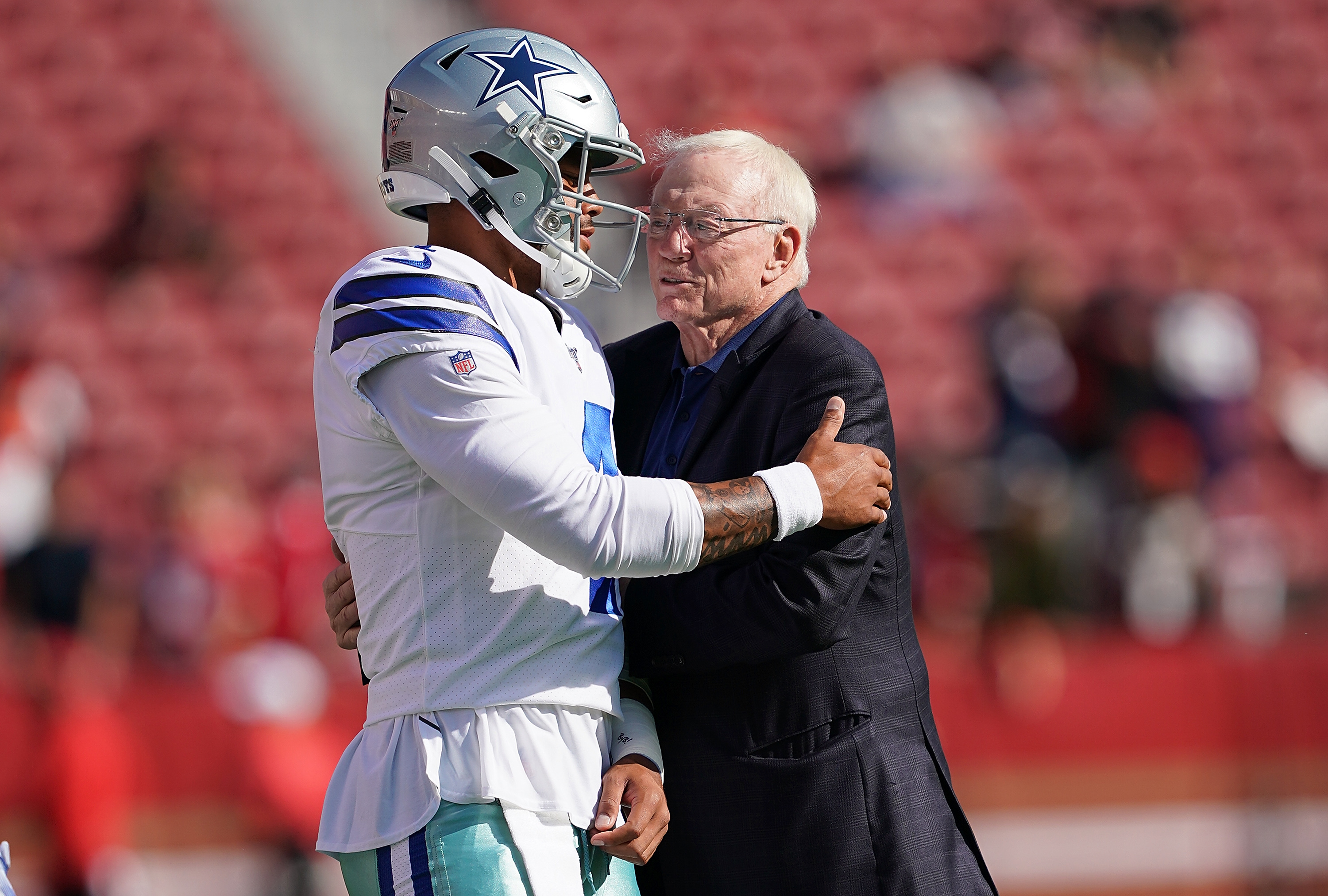 SANTA CLARA, CA - AUGUST 10: Quarterback Dak Prescott #4 and team owner Jerry Jones of the Dallas Cowboys hug each other during pregame warm ups prior to the start of an NFL preseason football game against the San Francisco 49ers at Levi's Stadium on August 10, 2019 in Santa Clara, California. (Photo by Thearon W. Henderson/Getty Images)
