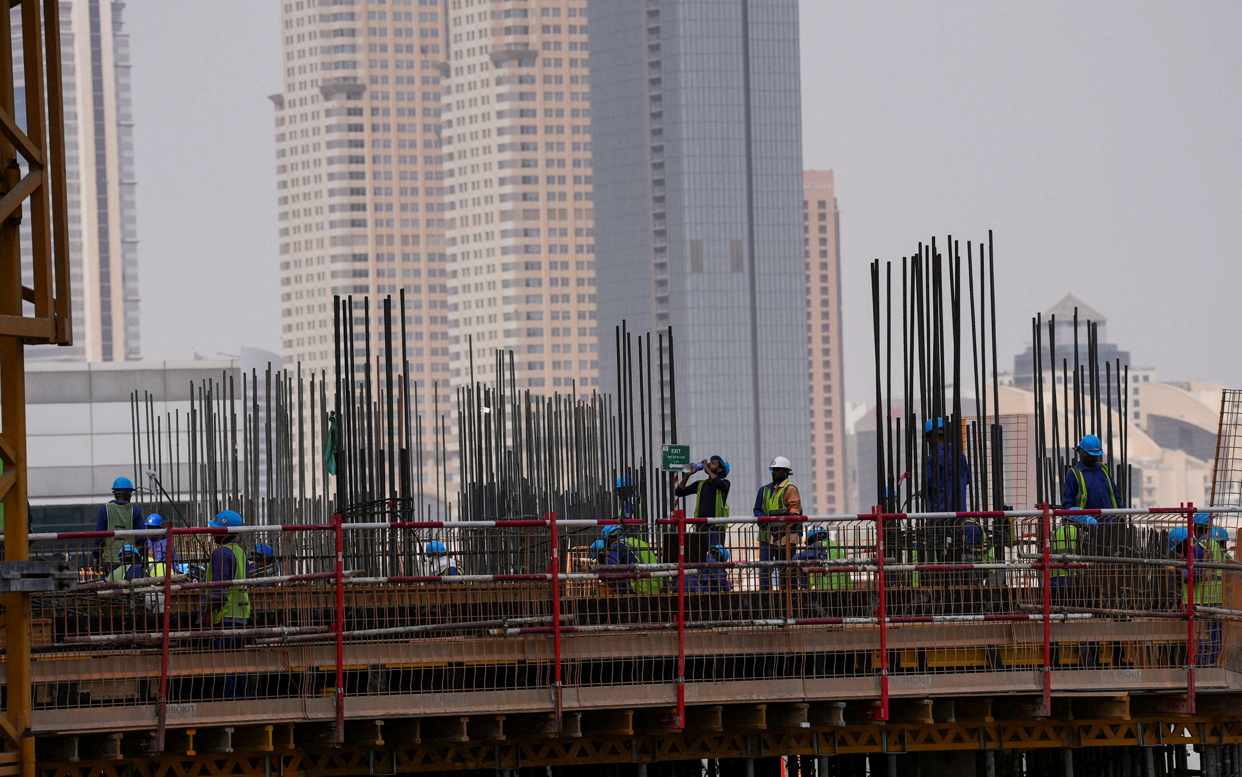A worker drinks water as he works during a heatwave in Dubai, United Arab Emirates, August 2, 2025. REUTERS/Raghed Waked