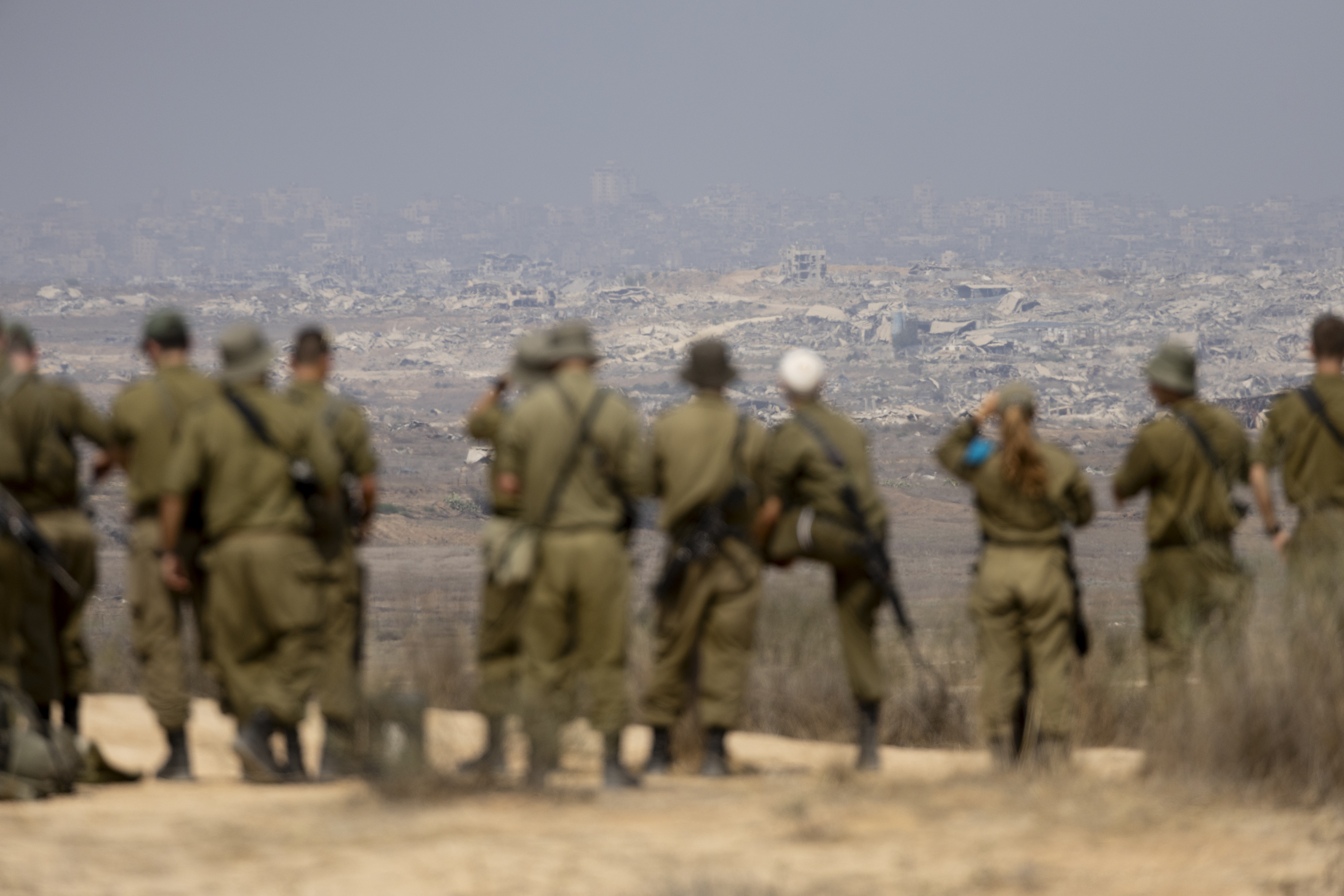 SOUTHERN ISRAEL, ISRAEL - AUGUST 13: Israeli soldiers look at destructed buildings in the Northern Gaza Strip as they are standing at a view point on the Israeli side of the border on August 13, 2025 in Southern Israel, Israel. Last week Israel's security cabinet approved Prime Minister Benjamin Netanyahu's proposal to expand IDF occupation of the Gaza Strip, including taking 
