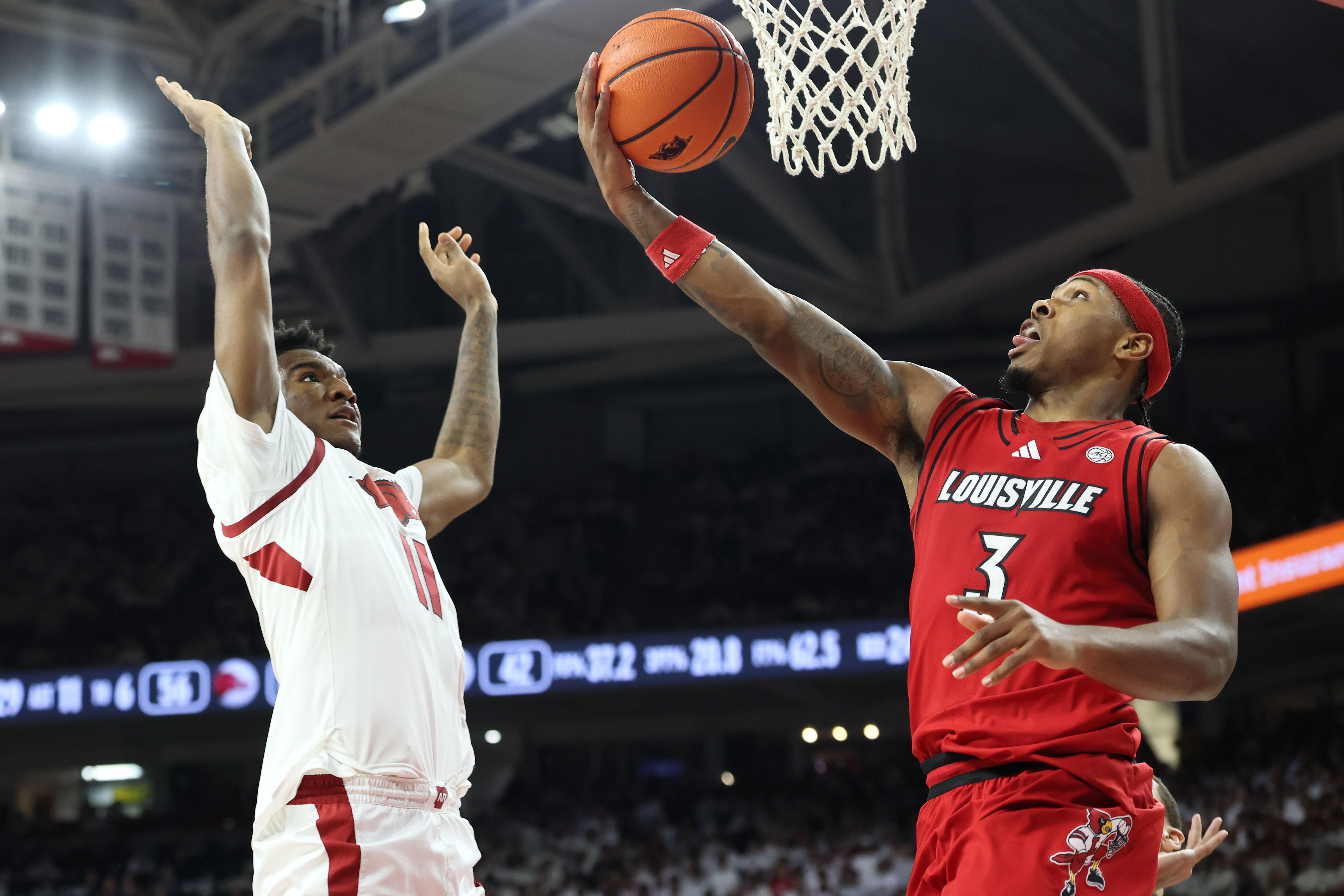 Dec 3, 2025; Fayetteville, Arkansas, USA; Louisville Cardinals guard Ryan Conwell (3) shoots against Arkansas Razorbacks wing Karter Knox (11) during the second half at Bud Walton Arena. Arkansas won 89-80. Mandatory Credit: Nelson Chenault-Imagn Images