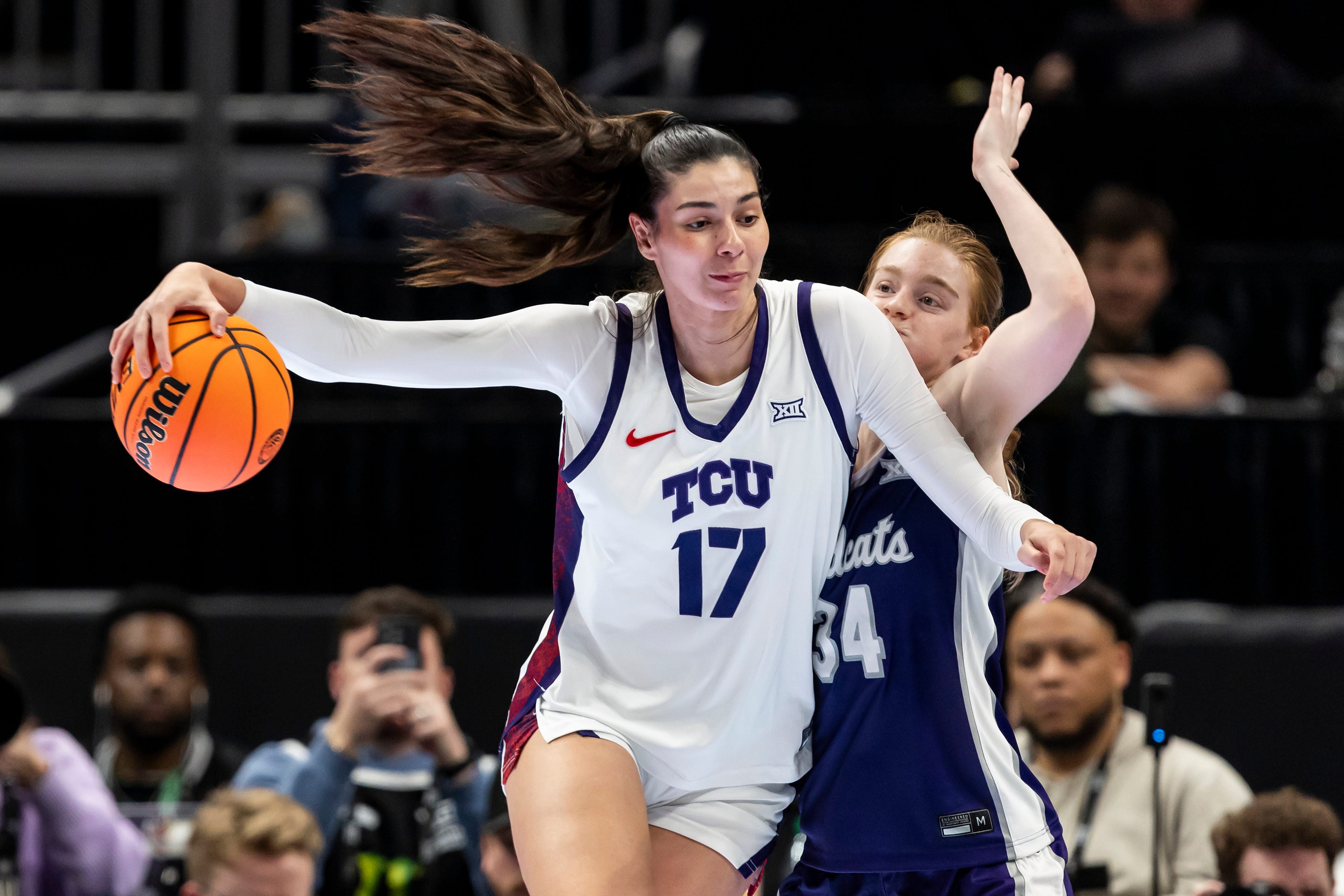 Mar 7, 2026; Kansas City, MO, USA; TCU Horned Frogs center Clara Silva (17) attempts to edge around Kansas State Wildcats guard Tess Heal (34) during the first half at T-Mobile Center. Mandatory Credit: Nick Tre. Smith-Imagn Images