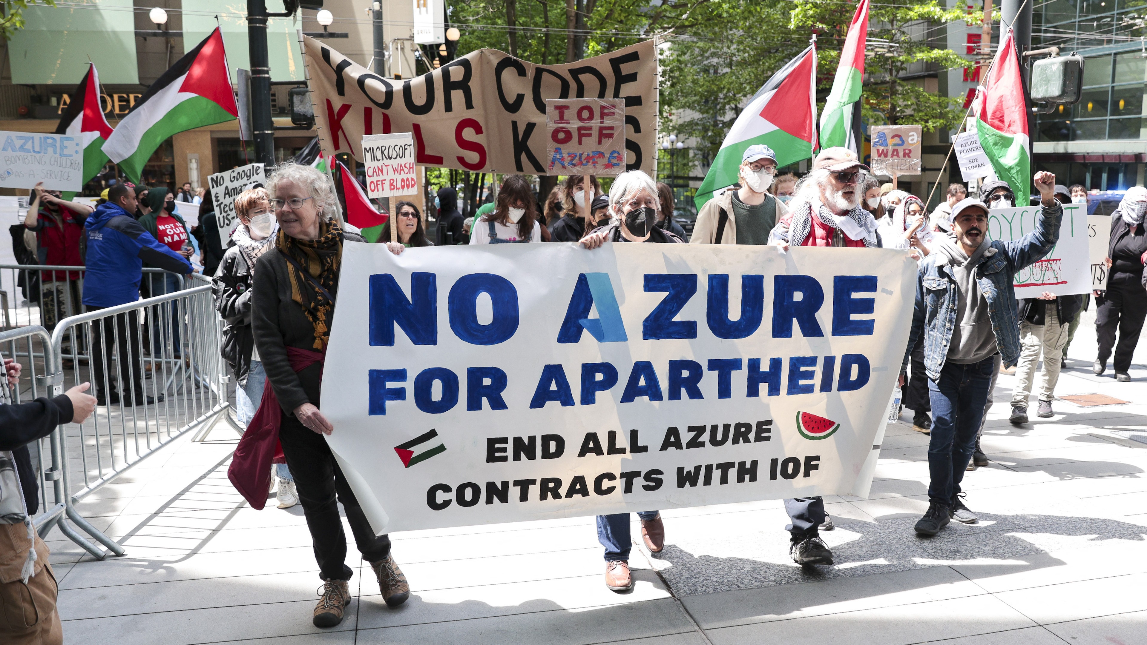 Pro-Palestinian demonstrators hold banners and signs as they protest outside the Microsoft Build conference at the Seattle Convention Center in Seattle, Washington on May 19, 2025. (Photo by Jason Redmond / AFP) (Photo by JASON REDMOND/AFP via Getty Images)