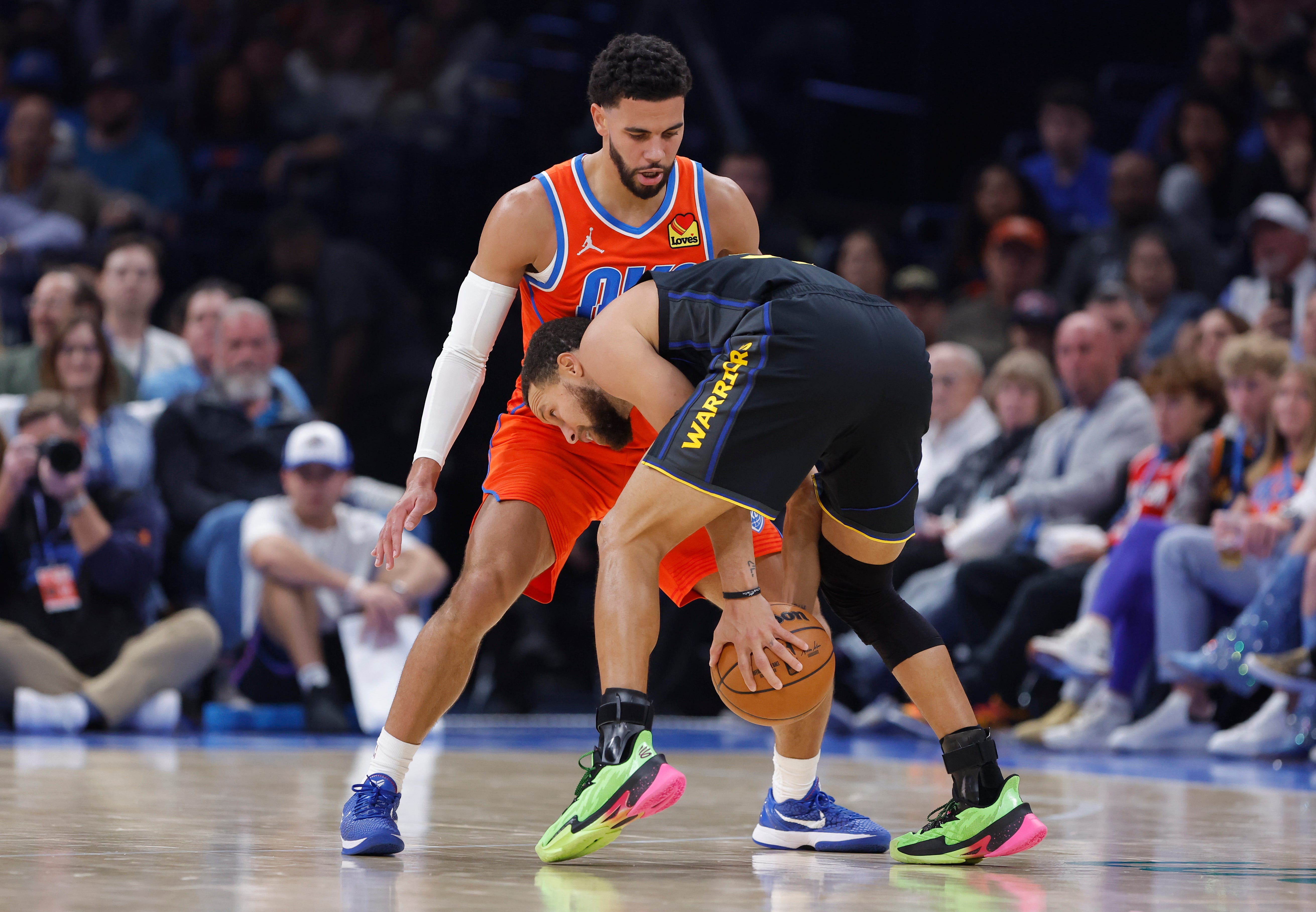 Nov 11, 2025; Oklahoma City, Oklahoma, USA; Oklahoma City Thunder guard Ajay Mitchell (25) defends a drive by Golden State Warriors guard Stephen Curry (30) during the second quarter at Paycom Center. Mandatory Credit: Alonzo Adams-Imagn Images