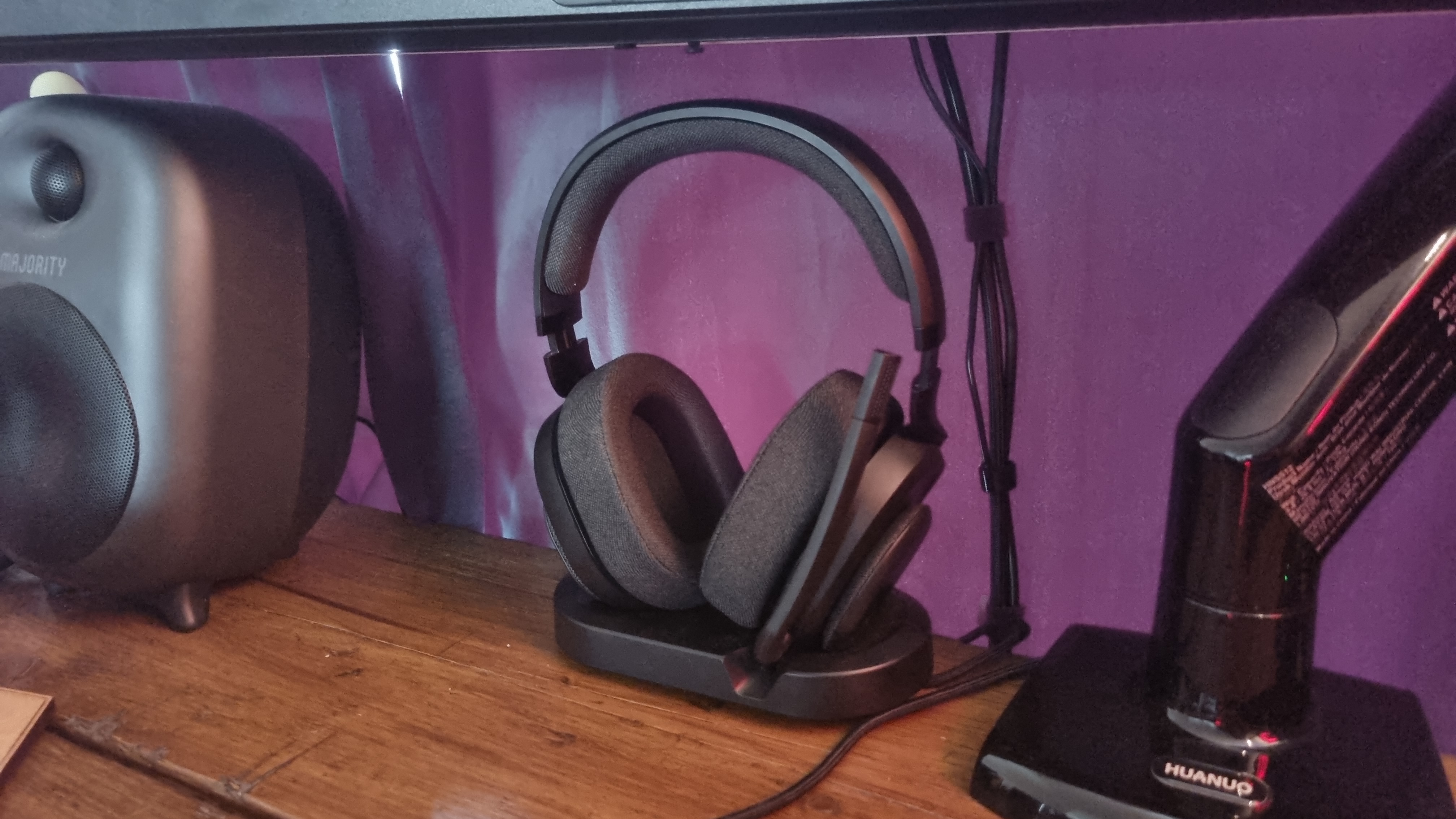 The Fractal Scape gaming headset atop its stand, on a desk