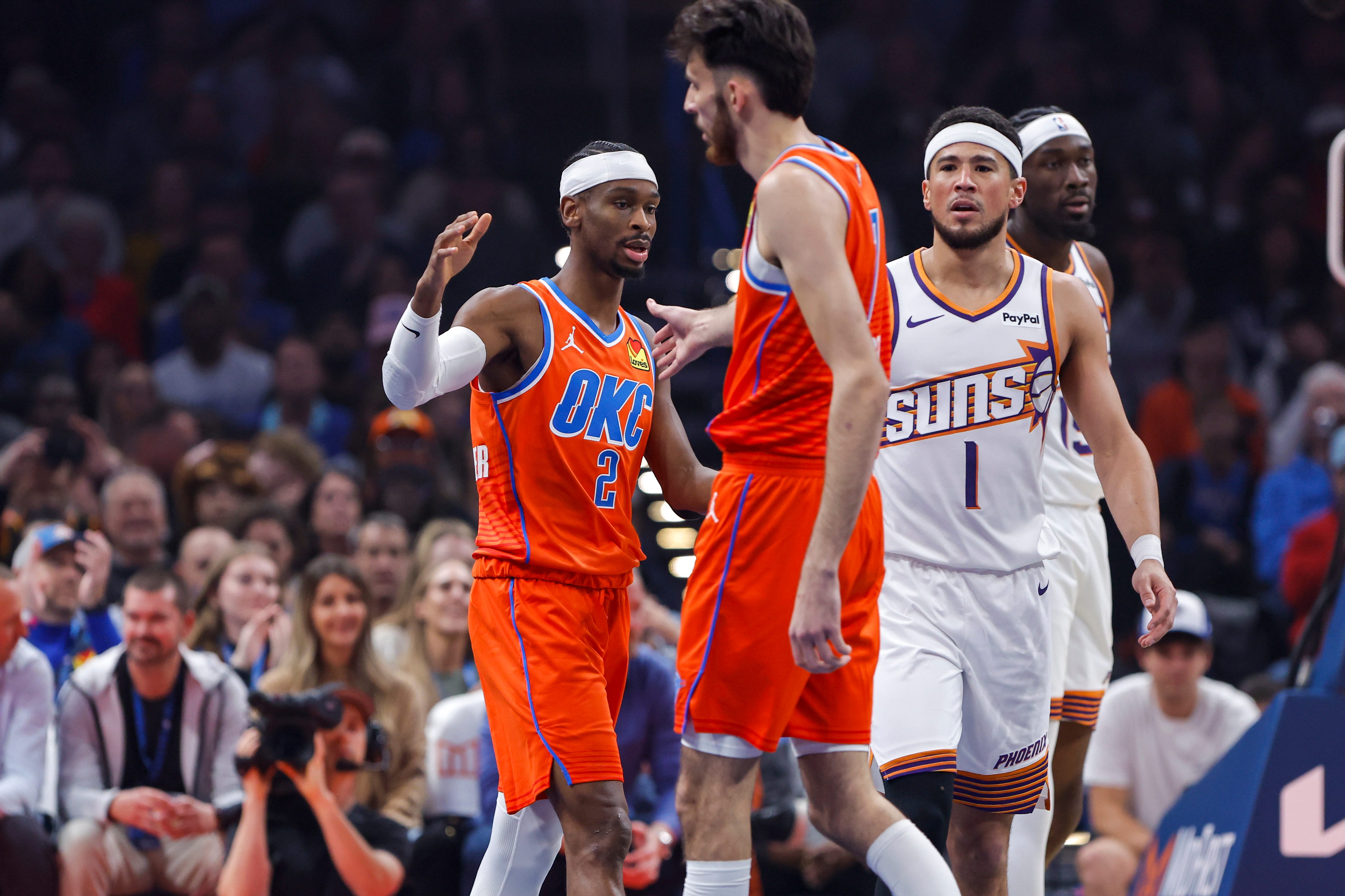 Nov 28, 2025; Oklahoma City, Oklahoma, USA; Oklahoma City Thunder guard Shai Gilgeous-Alexander (2) and center Chet Holmgren (7) high five after a play against the Phoenix Suns during the first quarter at Paycom Center. Mandatory Credit: Alonzo Adams-Imagn Images