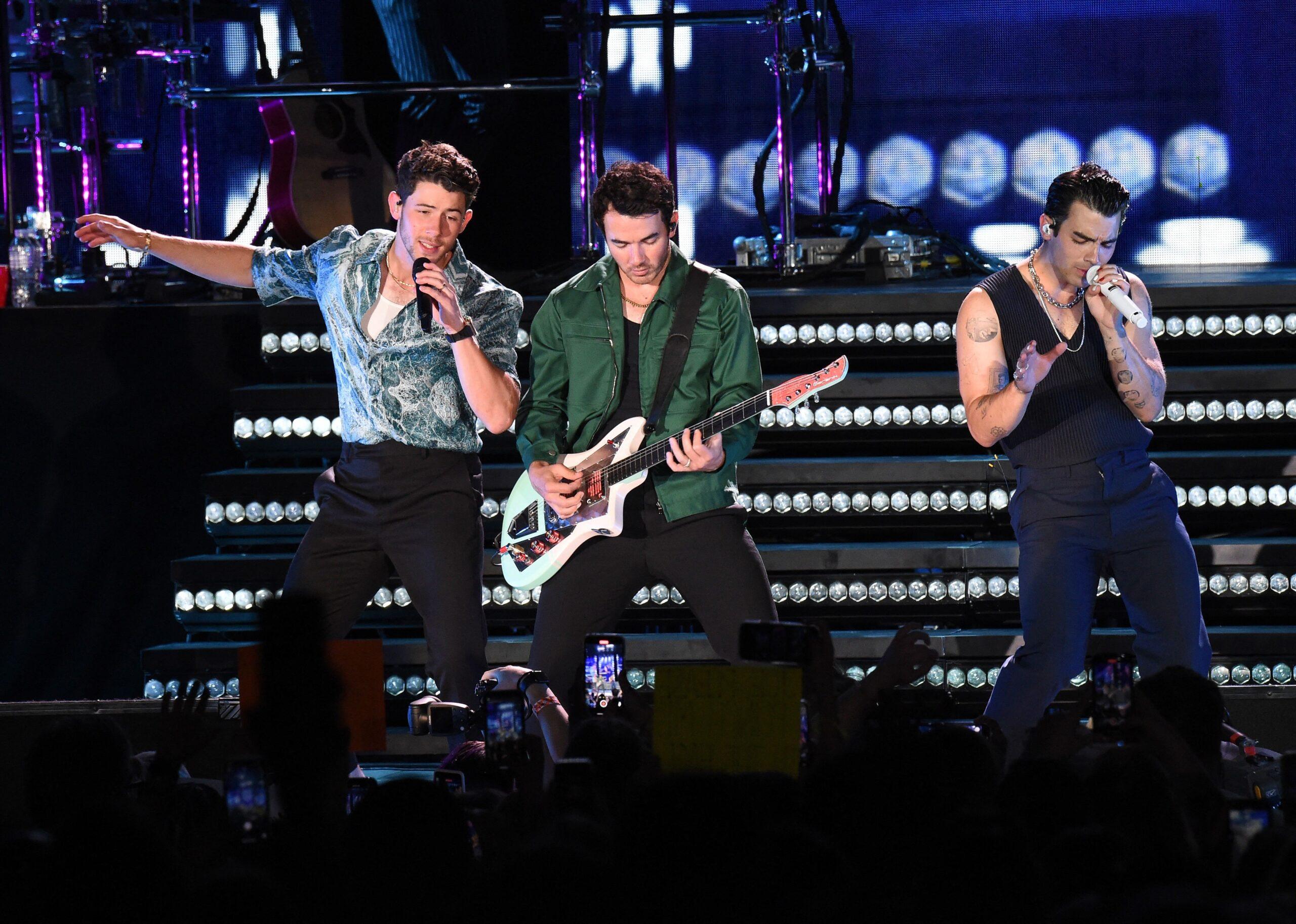 Nick, Kevin, and Joe Jonas on stage