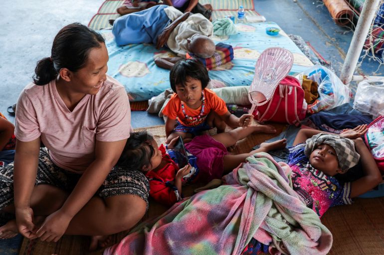 Jiraporn Philaphan, 34, who lived 5 km from the attached 7-Eleven convenience and gas station, which was hit by an artillery shell on July 24 and resulted in multiple fatalities, reacts with her children at a shelter following a ceasefire between Cambodia and Thailand, where displaced people have been staying since July 24, in Sisaket province, Thailand, August 1, 2025. REUTERS/Chalinee Thirasupa