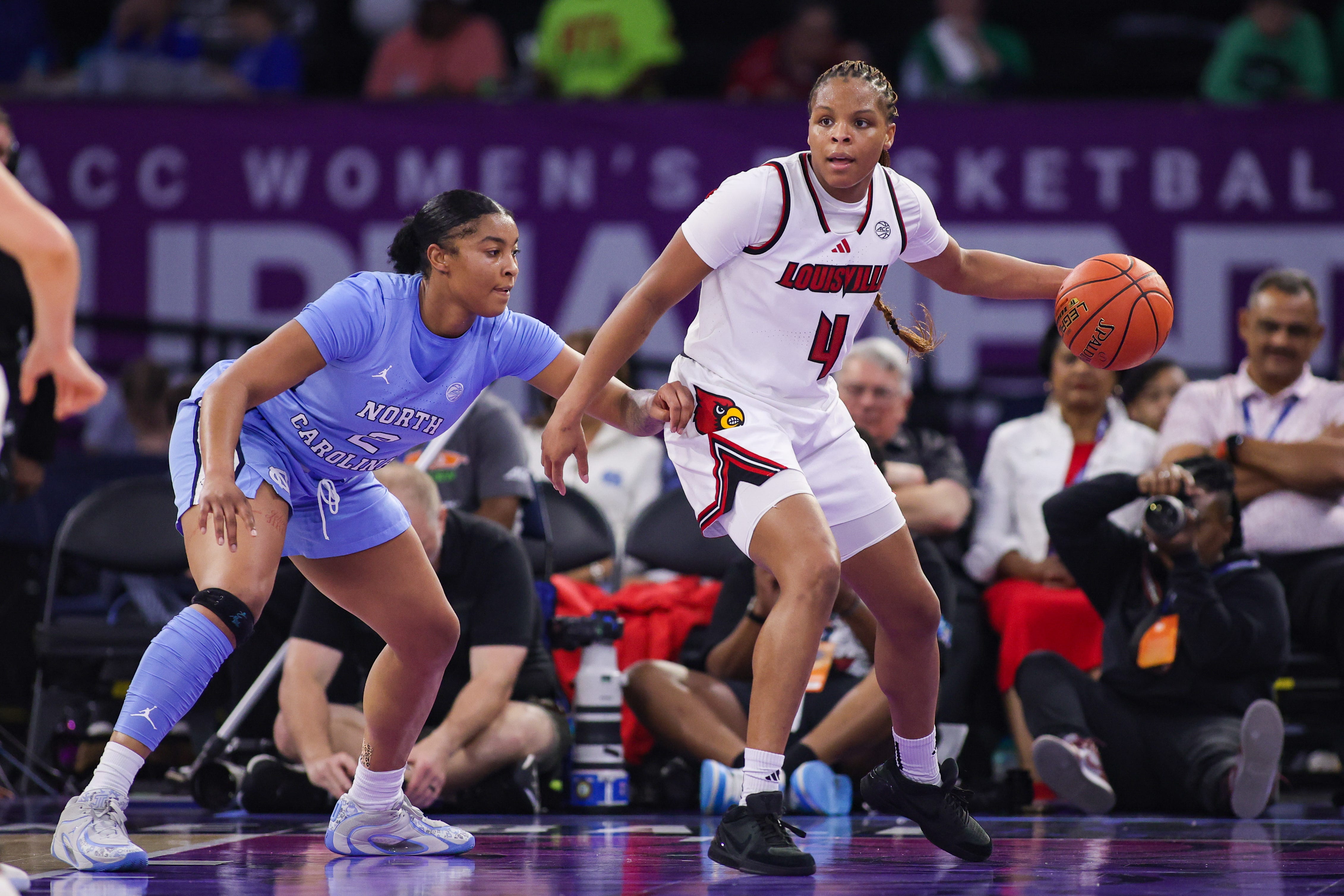 Mar 7, 2026; Duluth, GA, USA; Louisville Cardinals forward MacKenly Randolph (4) is defended by North Carolina Tar Heels forward Nyla Harris (2) in the second quarter at Gas South Arena. Mandatory Credit: Brett Davis-Imagn Images