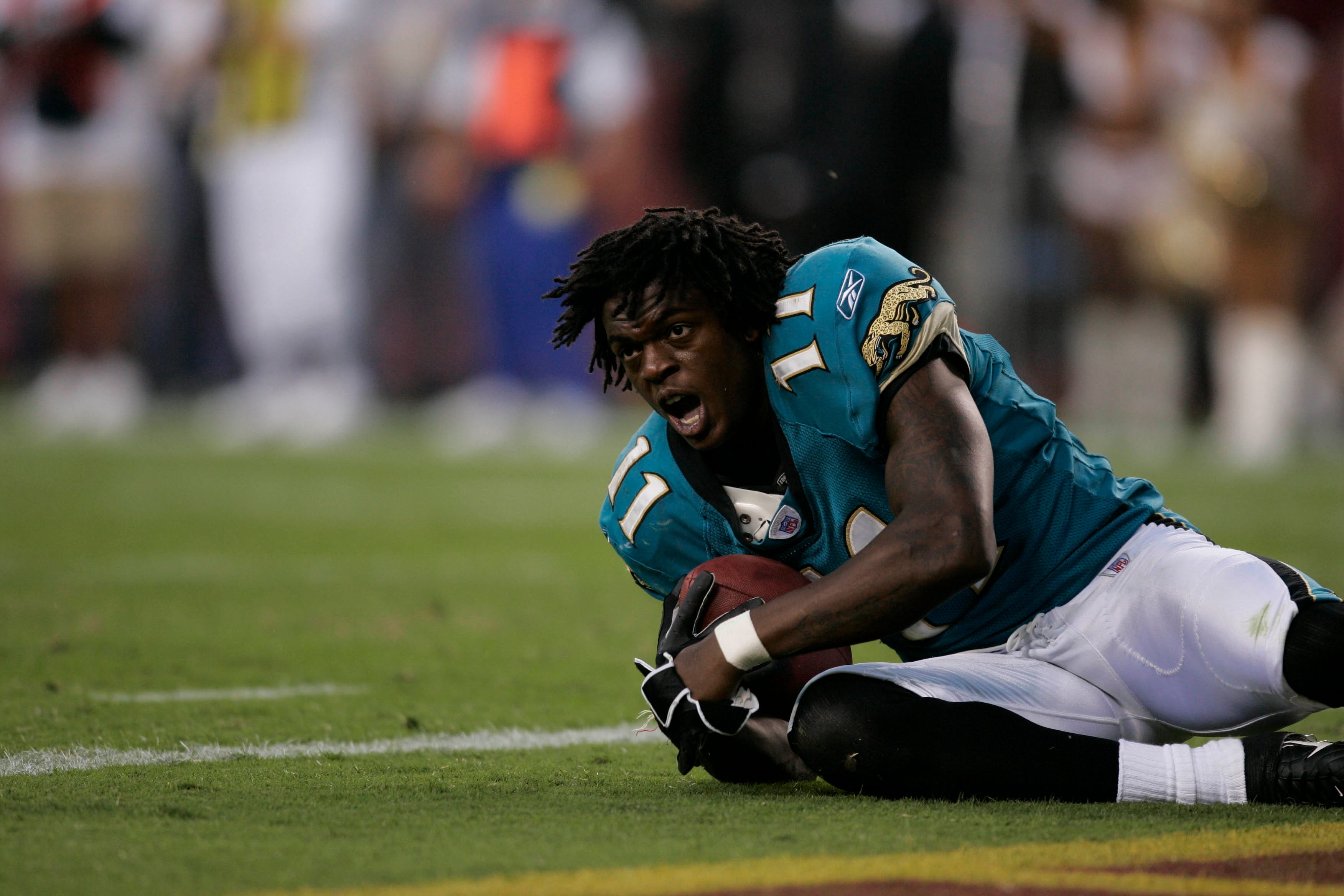 Jacksonville Jaguars wide receiver Reggie Williams reacts after having his helmet knocked off while scoring a touchdown in the fourth quarter at FedEx Field.