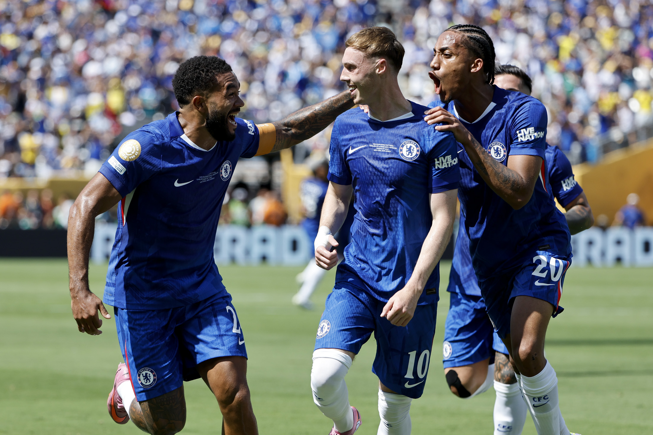 EAST RUTHERFORD, NEW JERSEY - JULY 13: Cole Palmer of Chelsea celebrates his goal between Reece James and Joao Pedro during the FIFA Club World Cup 2025 final football match between Chelsea FC and Paris Saint-Germain (PSG) at MetLife Stadium on July 13, 2025 in East Rutherford, New Jersey. (Photo by Jean Catuffe/Getty Images)