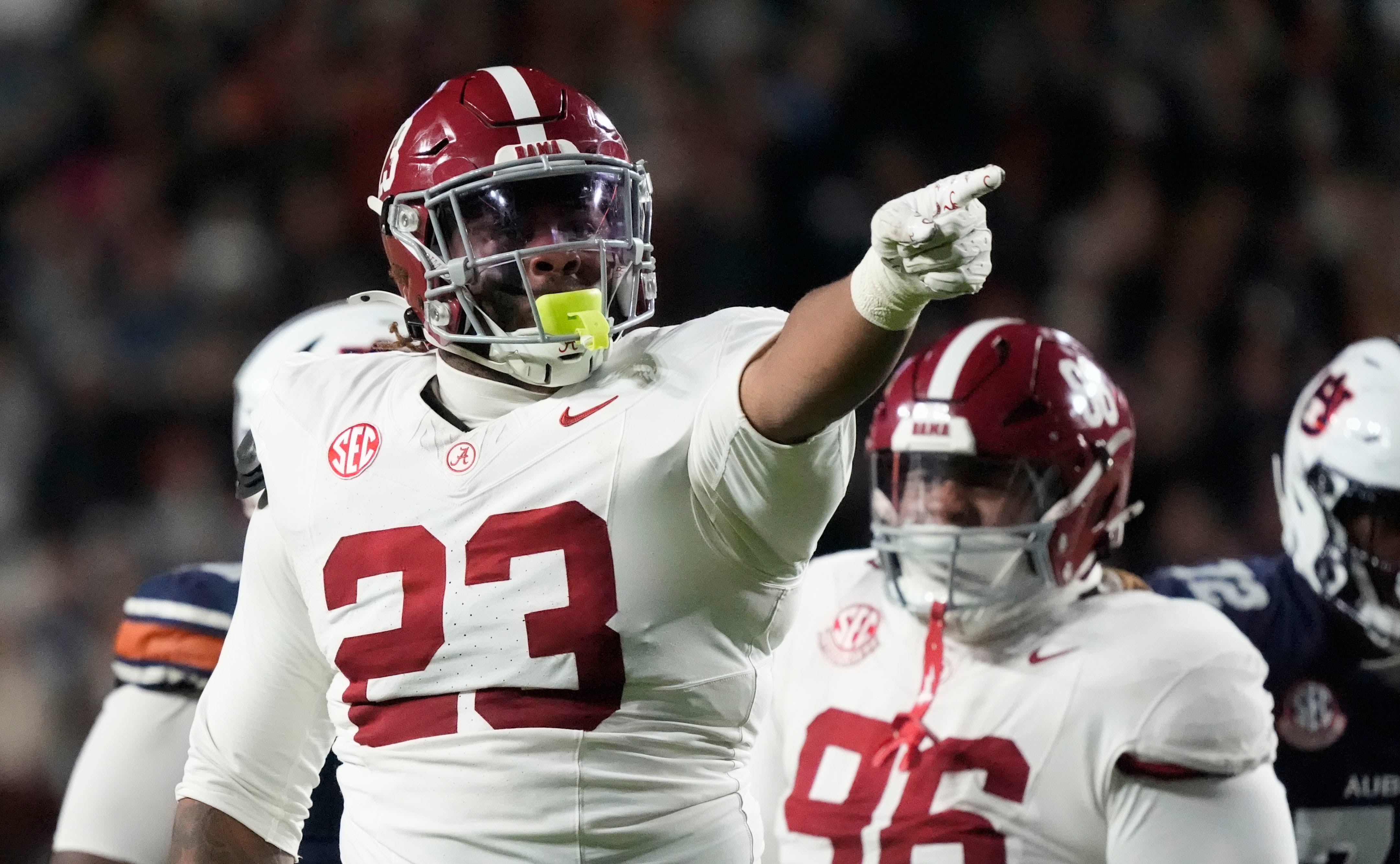 Nov 29, 2025; Auburn, Alabama, USA; Alabama defensive lineman James Smith (23) celebrates his sack of Auburn quarterback Ashton Daniels (12) at Jordan-Hare Stadium. Mandatory Credit: Gary Cosby Jr.-Tuscaloosa News